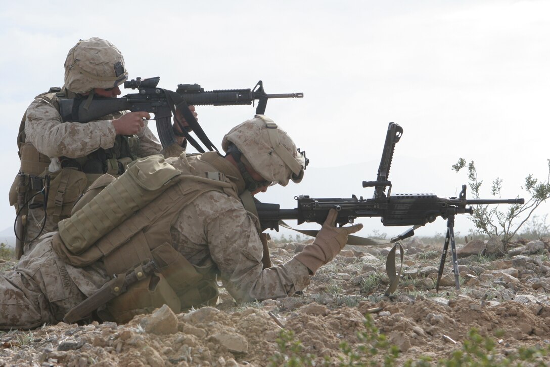 Cpl. Kyle Blades, team leader, 1st squad, 2nd platoon, Fox Company, 2/24, provides covering fire for Lance Cpl. Matt Shimon, SAW gunner, 2nd platoon, Fox Company, 2/24, while he reloads his weapon.