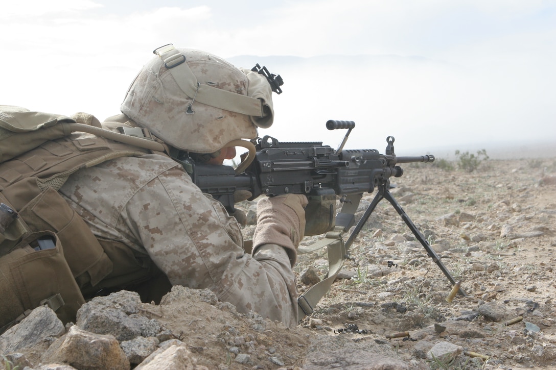 Lance Cpl. Matt Shimon, SAW gunner, 1st squad, 2nd platoon, Fox Company, 2/24, cuts through the smoke of an aircraft, artillery and mortar bombardment with rounds from his SAW.