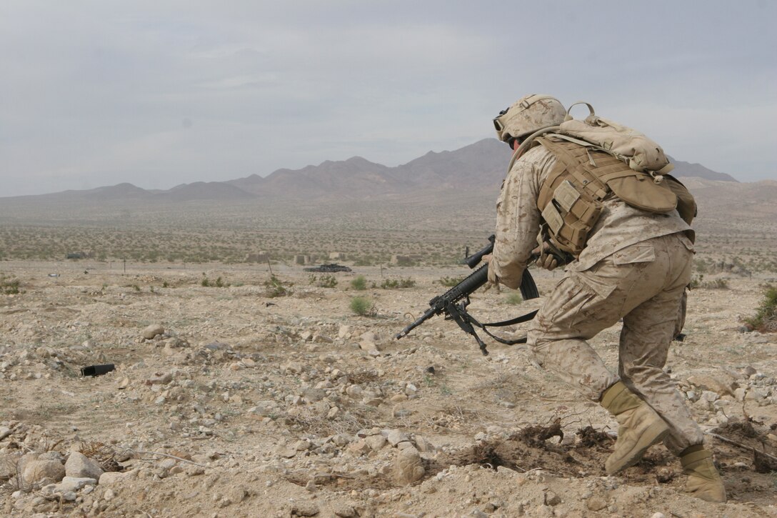 Lance Cpl. Andrew Morgan, designated marksman, 1st squad, 2nd platoon, Fox Company, 2/24, fires precision shots at an enemy bunker.