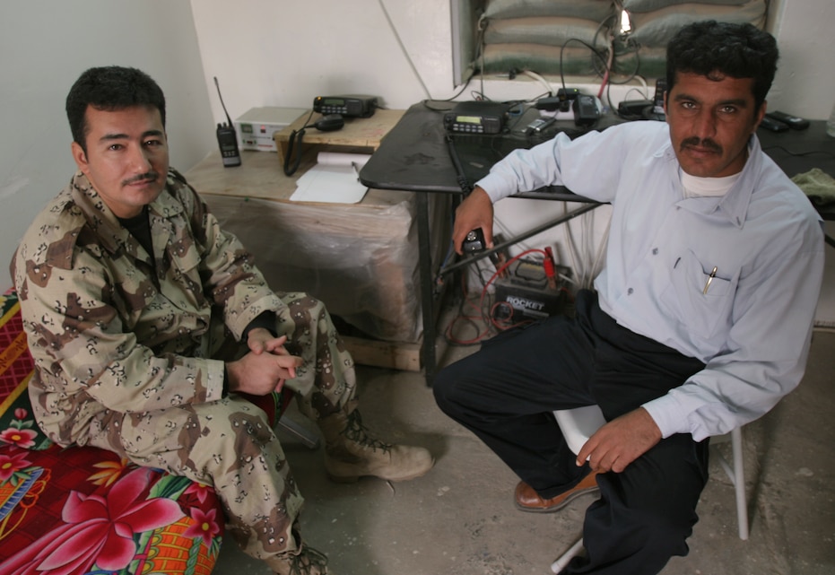 Rafea A. Hussien, an Iraqi soldier (left) and Amir S. Musa, a 38-year-old Iraqi policeman (right), monitor the radios in the communications room of the Joint Security Station here, Dec. 10, 2007.  Open since late July, the JSS houses Iraqi Police and Marines of 1st Battalion, 1st Marine Regiment, Regimental Combat Team 6.  It serves as a combined operations center for the Iraqi Army, Iraqi Police and Coalition Forces in the area.  It is responsible for bringing a face to something that has been present for some time here: cooperation, coordination and peace through a mutual understanding of cultures and goals for the future.