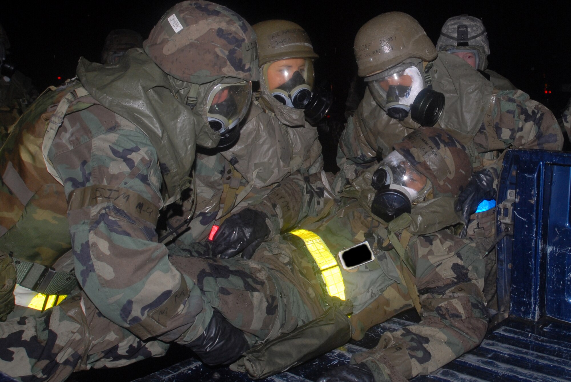 Airmen assigned to the 18th Munitions Squadron, Precision Guided Munitions shop, place a victim with severe head wounds into the back of a truck to be transported to the hospital, as part of the Conventional Ground Hit missile attack during Local Operational Readiness Exercise Beverly High 08-2 at Kadena Air Base, Japan, Dec. 7, 2007. The exercise provided realistic training to help Kadena Airmen improve combat readiness skills.
(U.S. Air Force photo illustration/Staff Sgt. Chrissy FitzGerald)

