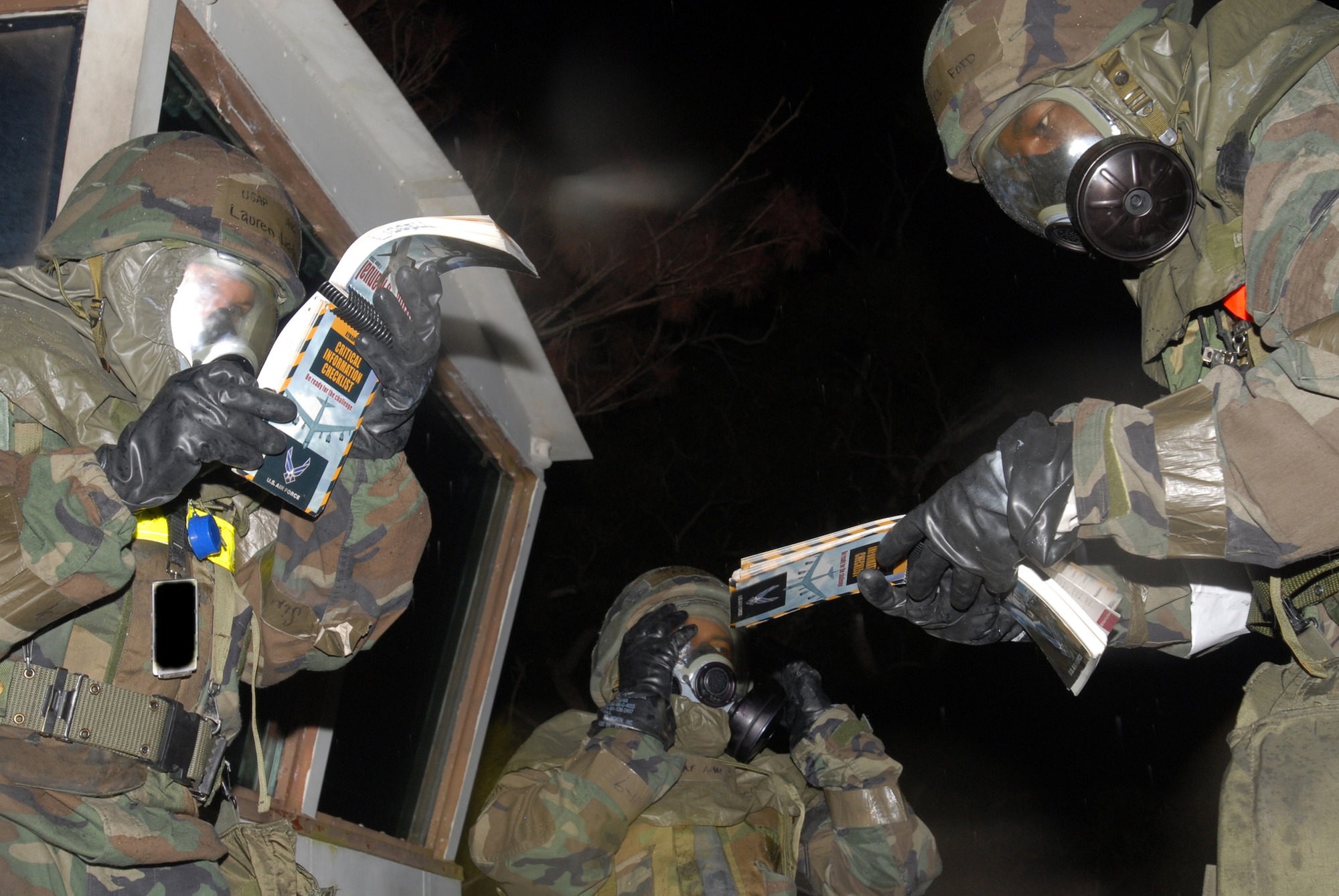 Airman 1st Class Lauren Liddell and Airman 1st Class Maurice Ford, 18th Munitions Squadron Precision Guided Munitions shop, refer to their Airman's Manual to determine how to treat a victim with several small lacerations to the face and a broken jaw as part of a conventional missile attack scenario during Local Operational Readiness Exercise Beverly High 08-2 at Kadena Air Base, Japan, Dec. 7, 2007. The exercise provided Kadena Airmen realistic training to help improve their combat readiness skills.
(U.S. Air Force photo illustration/Staff Sgt. Chrissy FitzGerald) 