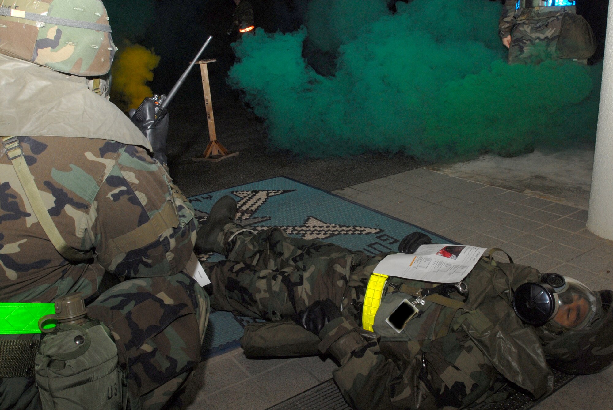 An Airman assigned to the 18th Munitions Squadron Precision Guided Munitions shop, informs the MUNS Control Center of a victim with a severe head wound needing transportation to the hospital as part of a conventional missile attack scenario during Local Operational Readiness Exercise Beverly High 08-2 at Kadena Air Base, Japan, Dec. 7, 2007. The exerrcise provide Kadena Airmen realistic training to help improve their combat readiness skills.
(U.S. Air Force photo illustration/Staff Sgt. Chrissy FitzGerald) 
