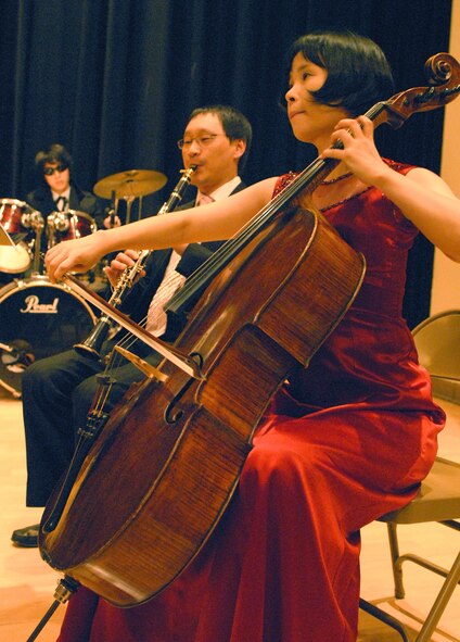 OSAN AIR BASE, Republic of Korea --  Chung, Young-Ann, on the cello, and Kim, Myong Pyo, on the clarinet, play the song "Tonight" during the finale of the Pyeongtaek Universtiy Concert at Osan American High School on Dec. 5. This is the third year that students and professors from the universtiy's music department have entertained Team Osan. (U.S. Air Force photo by Senior Master Sgt. Marvin Krause)