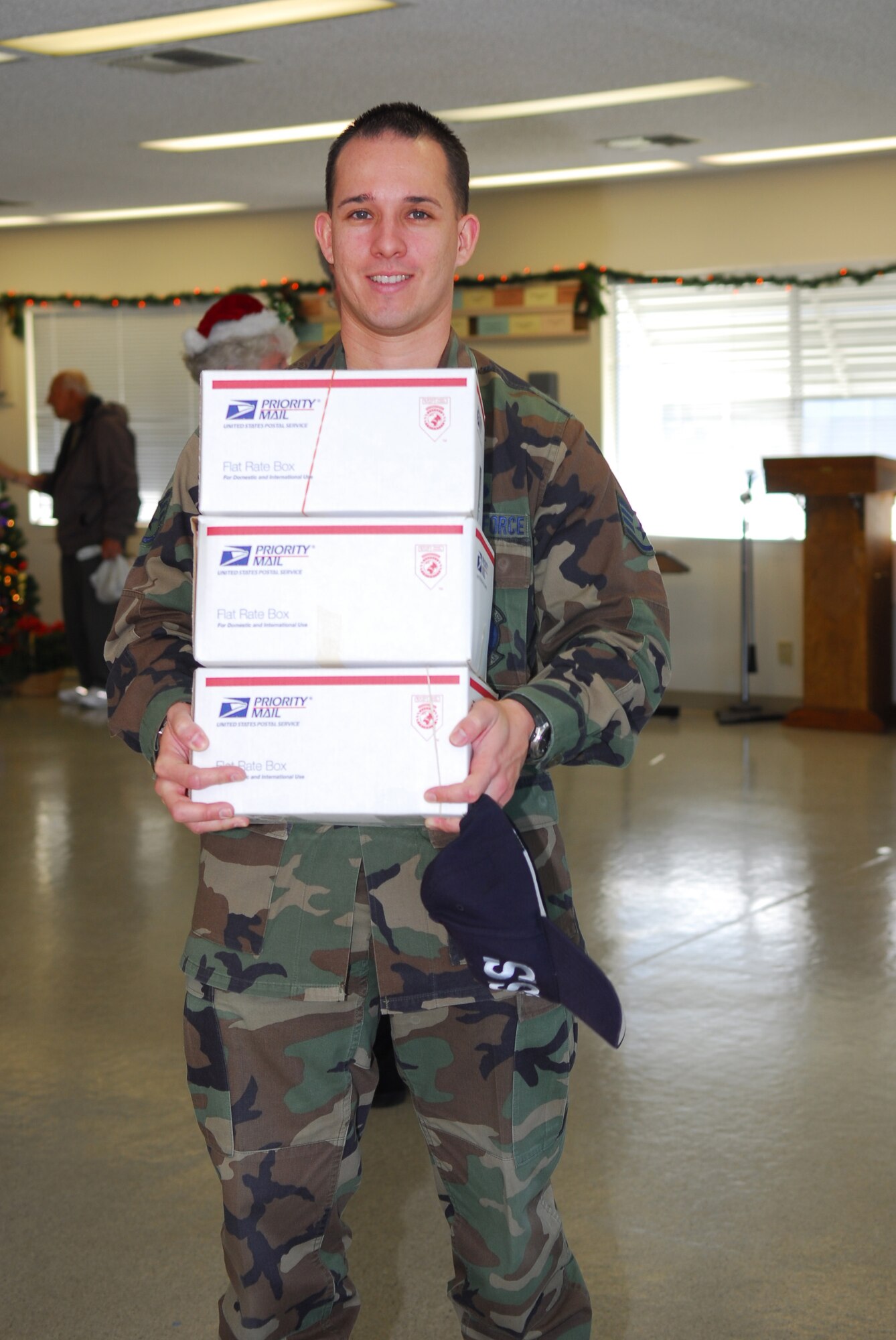 ORCUTT, Calif. --  Staff Sgt. Manuel Fernandez, 30 Mission Support Squadron, carries donated care packages at the Luis Oasis Senior Center to be sent to Vandenberg's deployed Airmen Dec. 5. The senior center, in conjunction with the services department, decided to give their yearly donation this year to those deployed without immediate families during the holidays. (U.S. Air Force photo/Airman 1st Class Ashley Tyler)