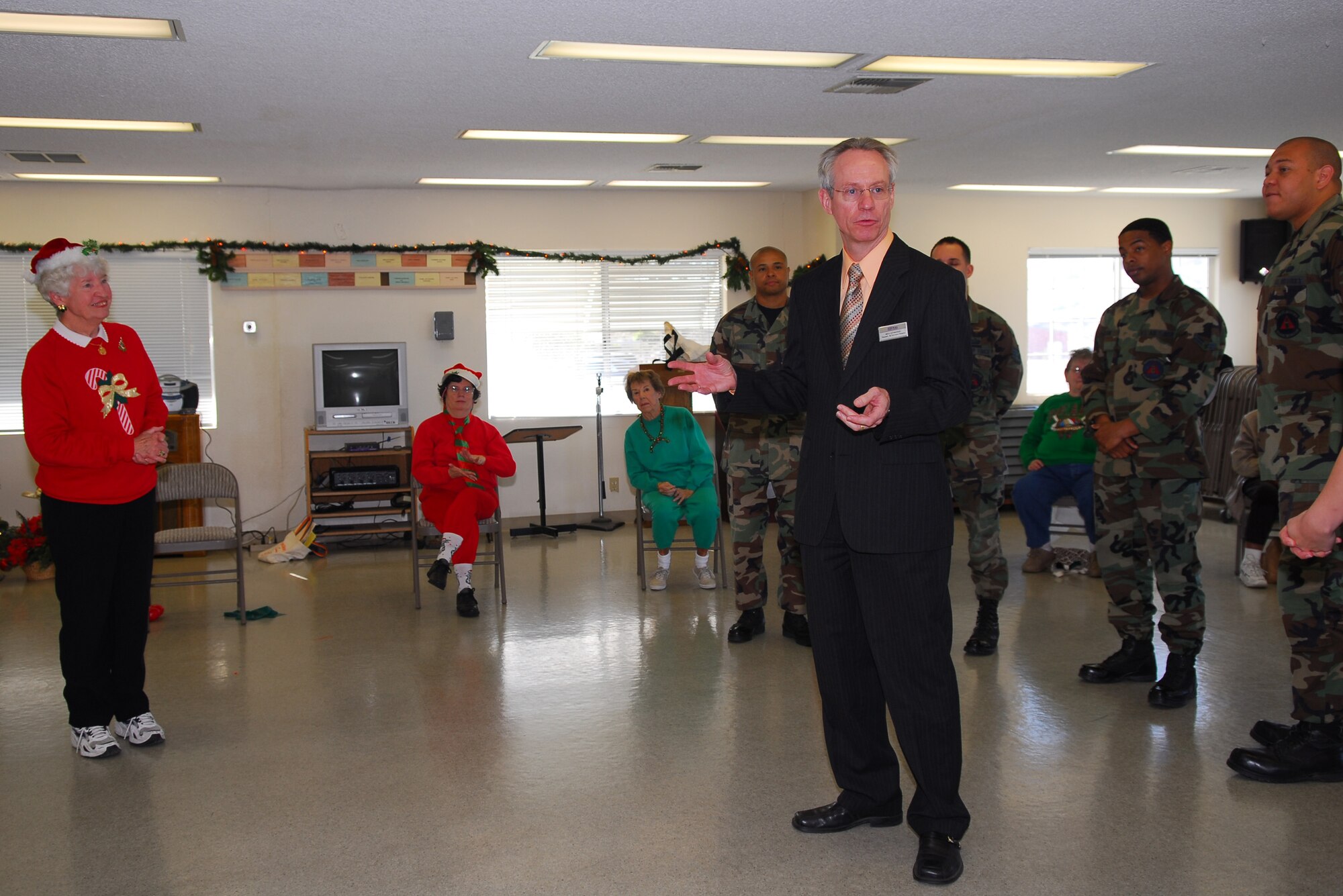 ORCUTT, Calif. --  Michael Szymanski, director of 30th Services Division, speaks with the residents of the Luis Oasis Senior Center on Dec. 5. The senior center, in conjunction with the services department, decided to give their yearly donation this year to those deployed without immediate families during the holidays.  (U.S. Air Force photo/Airman 1st Class Ashley Tyler)