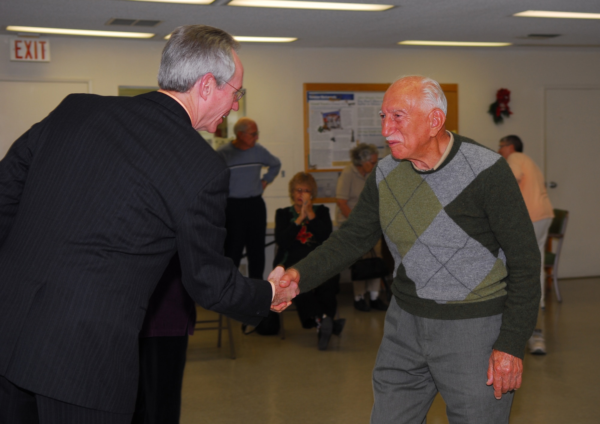 ORCUTT, Calif. --  Michael Szymanski, director of the 30th Services Division, meets with "Baba" while volunteering Airmen pick up and deliver "care" packages to Vandenberg's deployed at the Luis Oasis Senior Center Dec. 5. "Baba", which means grandfather, is from Iran and is visiting his granddaughter in Orcutt. The senior center, in conjunction with the services department, decided to give their yearly donation this year to those deployed without immediate families during the holidays.  (U.S. Air Force photo/Airman 1st Class Ashley Tyler)