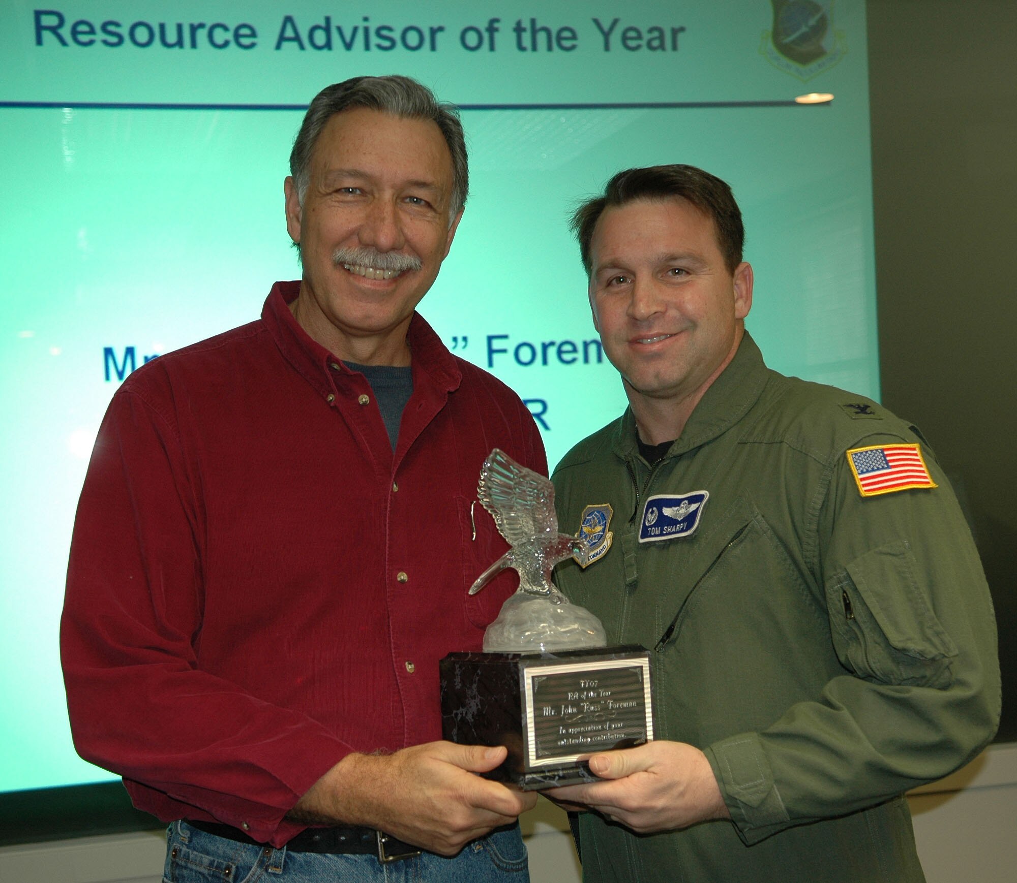 FAIRCHILD AIR FORCE BASE, Wash. -- Russ Foreman, 92nd Medical Group resource advisor, receives the 2007 92nd Air Refueling Wing Resource Advisor of the Year Award from Col. Thomas Sharpy, 92nd ARW commander. With the base-level award in hand, Mr. Foreman will compete at the Air Mobility Command level for resource advisor of the year. (U.S. Air Force photo/ Tech. Sgt. Larry W. Carpenter Jr.)