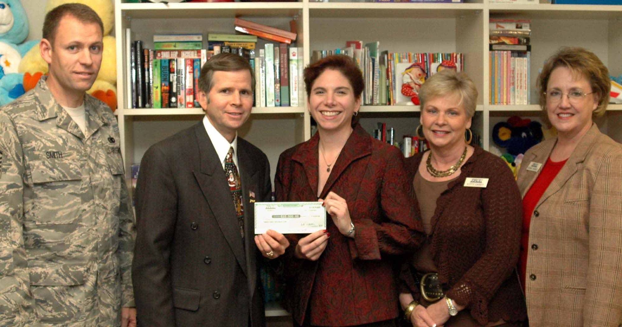 Tinker Federal Credit Union President and Chief Executive Officer Michael Kloiber, presents Jane Allen, Tinker Family Support Center director, with a $10,000 donation to support the Food Pantry and Airmen’s Attic programs.  Also pictured are, from left, Master Sgt. Gary Smith, Family Support Center superintendent, and Tinker Federal Credit Union staff members Kitty Casey, senior vice president of operations, and Donna Haines, senior vice president of lending. The Food Pantry and Airmen’s Attic provide humanitarian assistance for junior grade Airmen.   (Air Force photo by Ralph Monson)