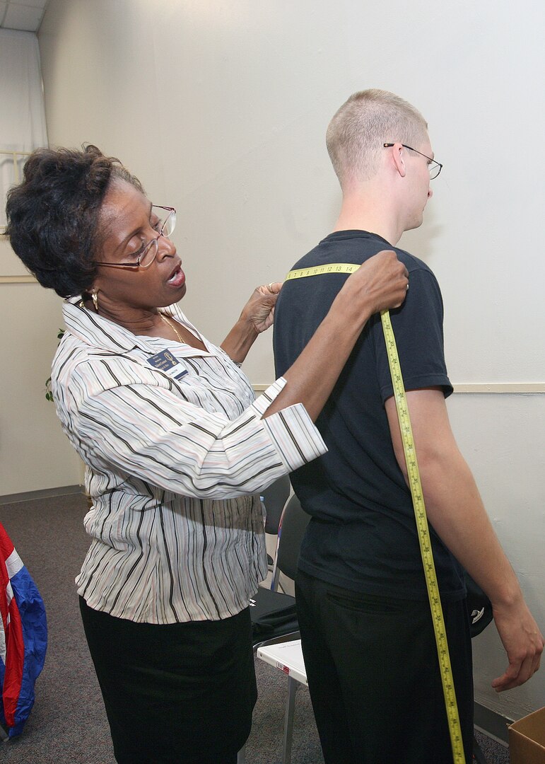 Gloria Singleton, 37th Mission Support Group, takes the measurements of Airman 1st Class Jaron Seleis on Monday at the Arnold Hall Community Center. Airmen from around the world are participating in the Worldwide Talent Contest this week on Lackland Air Force Base, Texas, where they will vie for positions on the 2008 Tops In Blue team. (USAF photo by Robbin Cresswell)