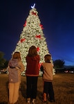 Erin, left, Nancy and John McClain admire the base Christmas tree at the Gateway Club Nov. 29. The children are the daughters and son of Stephanie and Chaplain (Capt.) L. Bryan McClain of the 37th Training Wing at Lackland Air Force Base, Texas. (USAF photo by Robbin Cresswell)