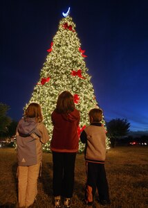 Erin, left, Nancy and John McClain admire the base Christmas tree at the Gateway Club Nov. 29. The children are the daughters and son of Stephanie and Chaplain (Capt.) L. Bryan McClain of the 37th Training Wing at Lackland Air Force Base, Texas. (USAF photo by Robbin Cresswell)