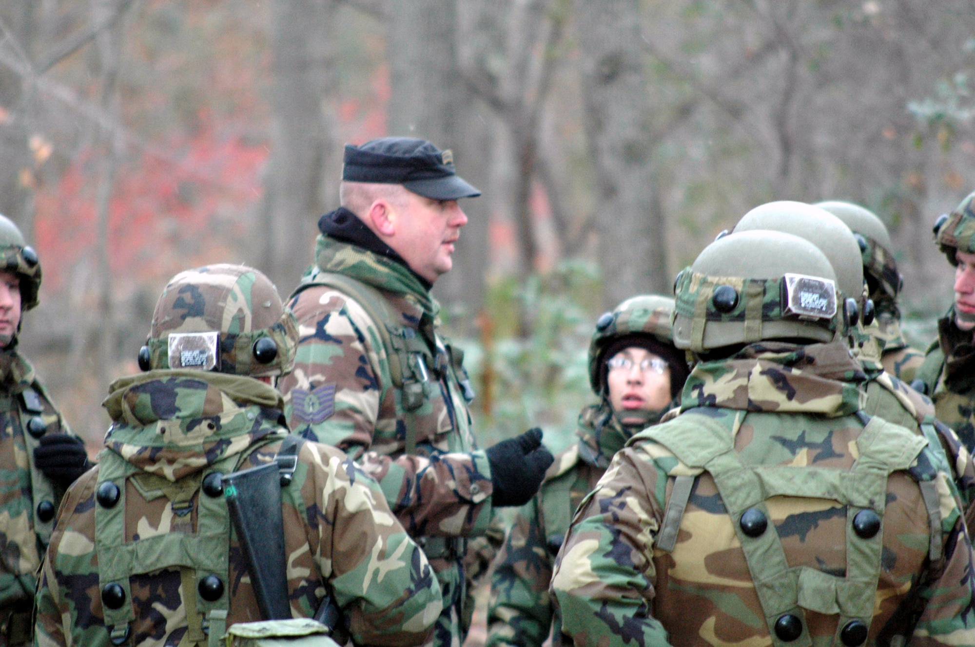 Tech. Sgt. Sam Young, contingency skills training instructor from the U.S. Air Force Expeditionary Center's 421st Combat Training Squadron, talks to students in the Air Force Advanced Contingency Skills Training Course 08-2 about combat tactics and patrolling during field training Dec. 4 on a range on Fort Dix, N.J.  The course is taught by the U.S. Air Force Expeditionary Center's 421st CTS and prepares Airmen for upcoming deployments.  (U.S. Air Force Photo/Tech. Sgt. Scott T. Sturkol) 