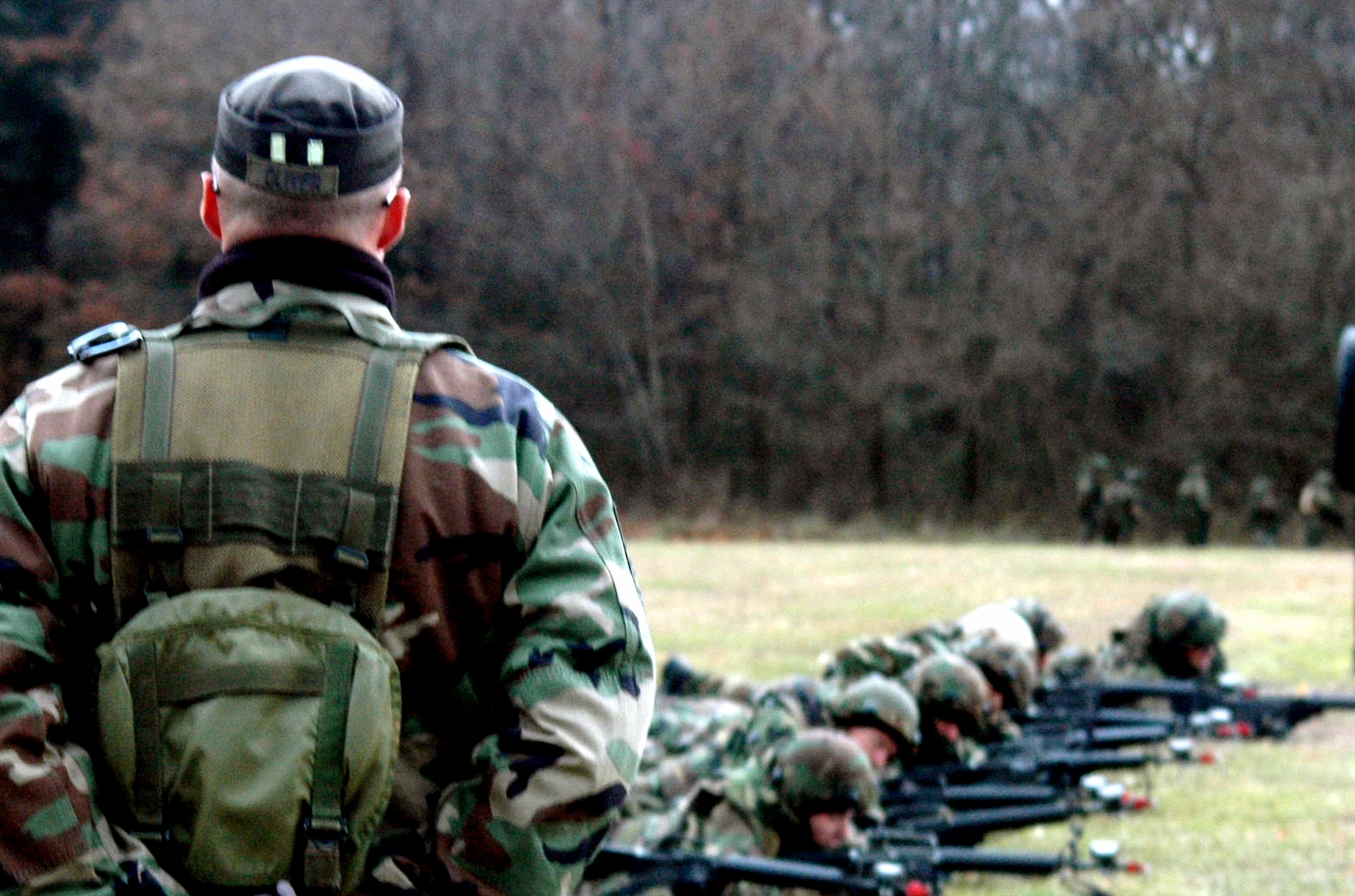 Tech. Sgt. Richard Oliver, contingency skills training instructor for the U.S. Air Force Expeditionary Center's 421st Combat Training Squadron, observes students in the Air Force Advanced Contingency Skills Training Course 08-2 during the field training for combat tactics and patrolling Dec. 4 on a range on Fort Dix, N.J.  The course is taught by the Center's 421st CTS and prepares Airmen for upcoming deployments.  (U.S. Air Force Photo/Tech. Sgt. Scott T. Sturkol) 