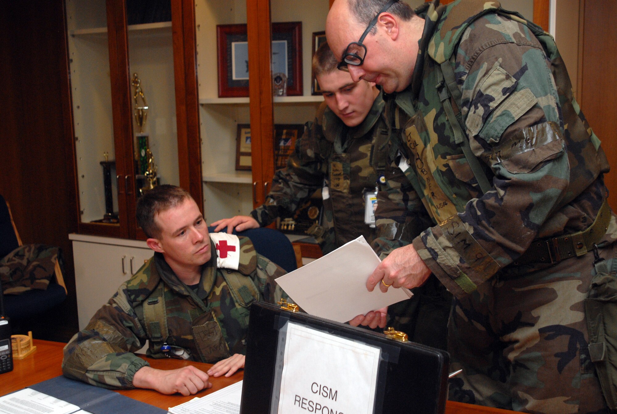 Tech. Sgt. Jason Sharp, Airman 1st Class Justin Beckett and Lt. Col. Mark Hubner, all from the 18th Medical Operations Squadron Mental Health clinic, review procedures to use in response to scenarios during Local Operational Readiness Exercise Beverly High 08-2 at Kadena Air Base, Japan, Dec. 5, 2007. These scenarios enable base agencies to work together, mitigate real-world situations, and heighten readiness capabilities.
(U.S. Air Force photo/Staff Sgt. Christopher Marasky)
