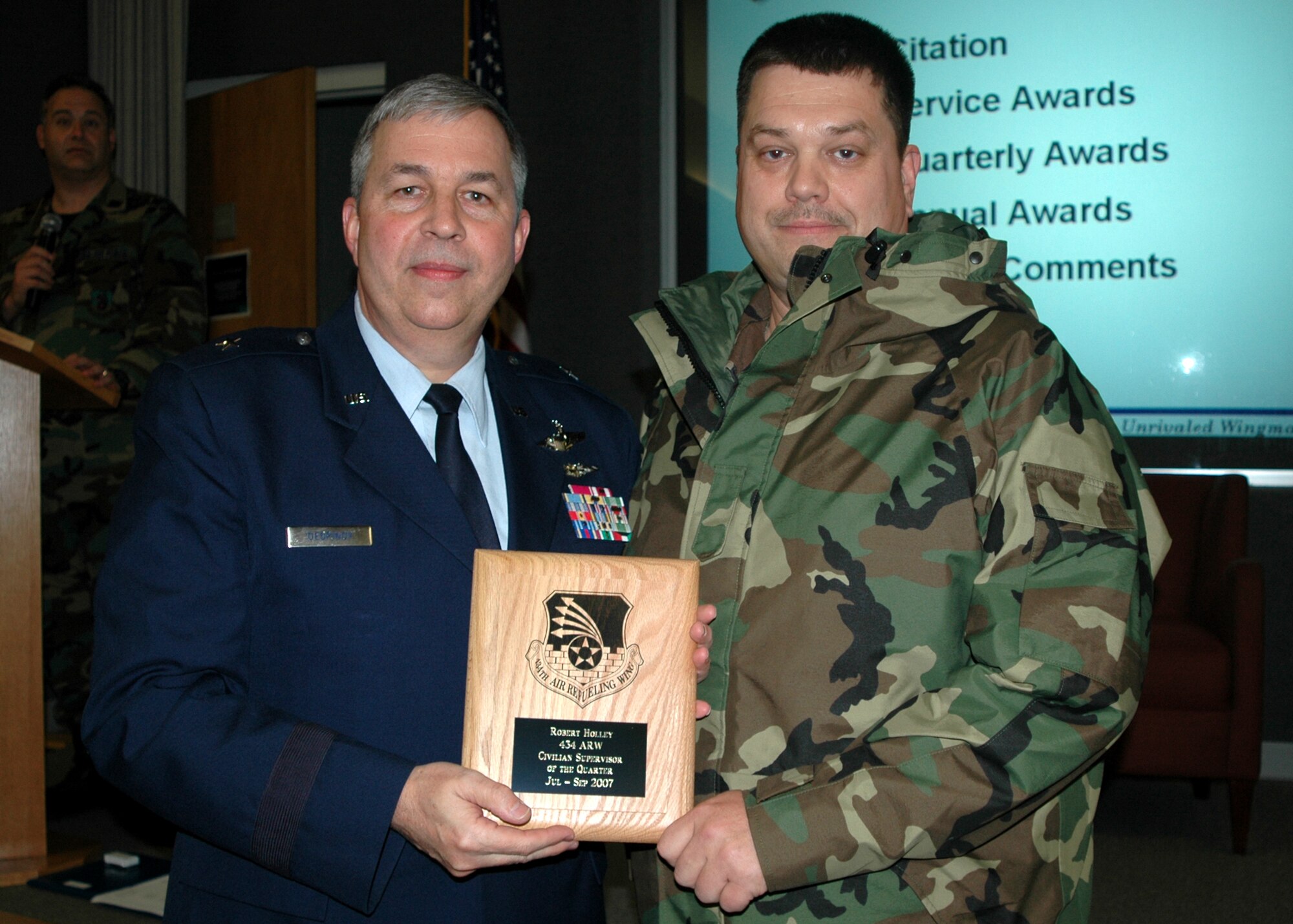 GRISSOM AIR RESERVE BASE, Ind., -- Brig. Gen. Dean Despinoy, 434th Air Refueling Wing commander, left, presents Senior Master Sgt. Robert Holley, an aerospace ground equipment specialist with the 434th Maintenance Squadron, a plaque in recognition of his selection as Grissom's Civilian Supervisor of the Quarter. The presentation was made during a recent civilian commander's call. (U.S. Air Force photo/Tech. Sgt. Douglas Hays)