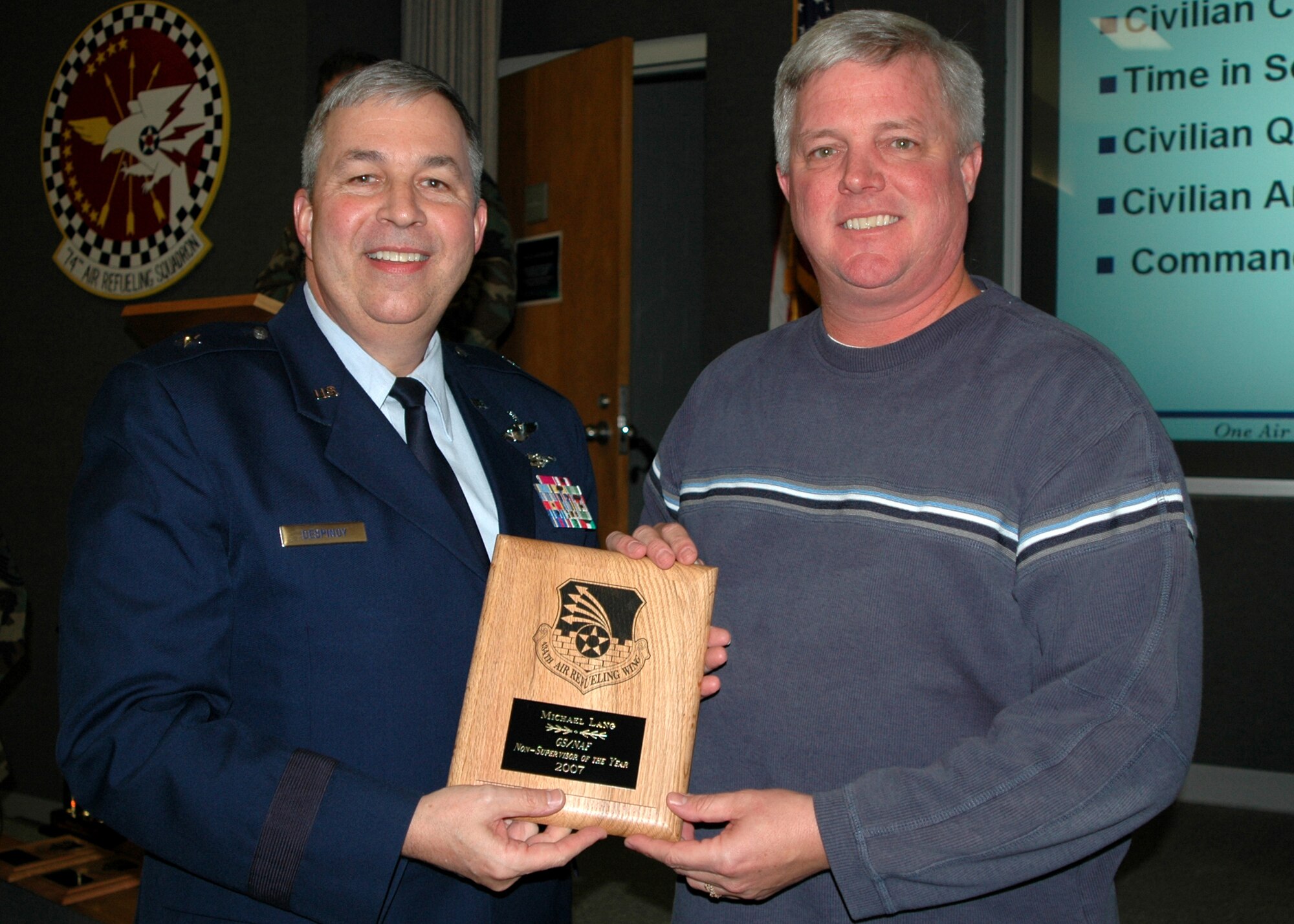 GRISSOM AIR RESERVE BASE, Ind., -- Brig. Gen. Dean Despinoy, 434th Air Refueling Wing commander, left, presents Michael Lang, an air traffic controller with the 434th Operations Support Squadron, a plaque for his selection as Grissom's GS/NAF Non-Supervisor of the Year for 2007. The presentation was made during a wing civilian commander's call recently. (U.S. Air Force photo/Tech. Sgt. Douglas Hays)