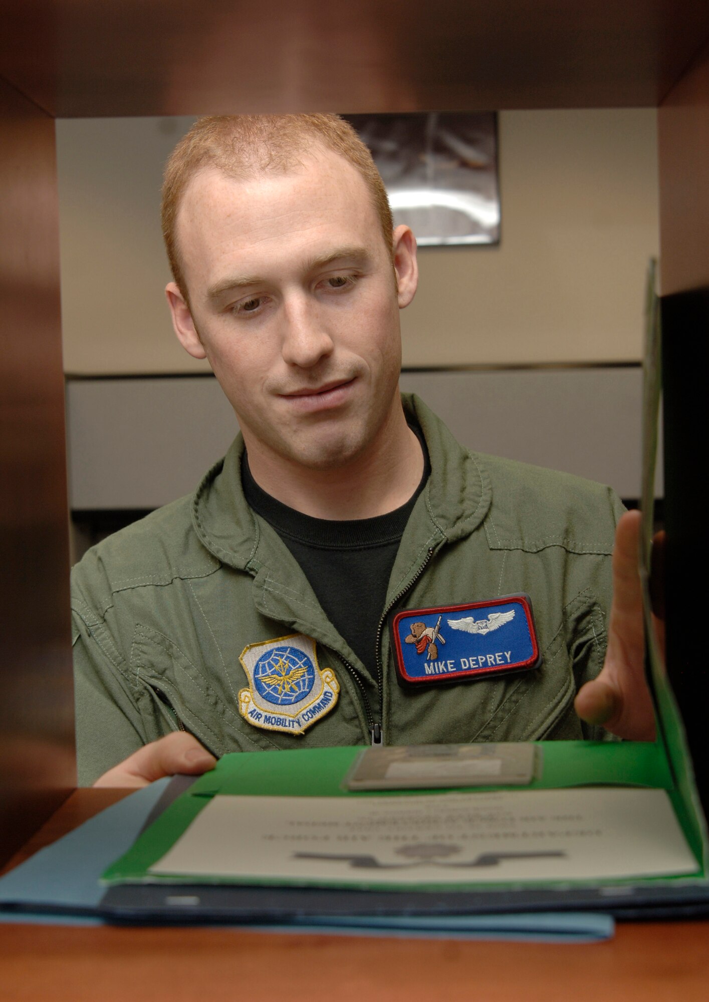 MCCONNELL AIR FORCE BASE, Kan. -- 1st Lt. Mike Deprey, 349th Air Refueling Squadron, looks at an award document on Nov. 26. 1st Lt Mike Deprey is an Executive Officer and his job deals with a lot of behind the scenes paper work like, Officer Performance Reports, Enlisted Performance Reports, award packages and also deal with new arrivals as well as departing Air Force Members. (Photo by Airman 1st Class Roy Lynch III)