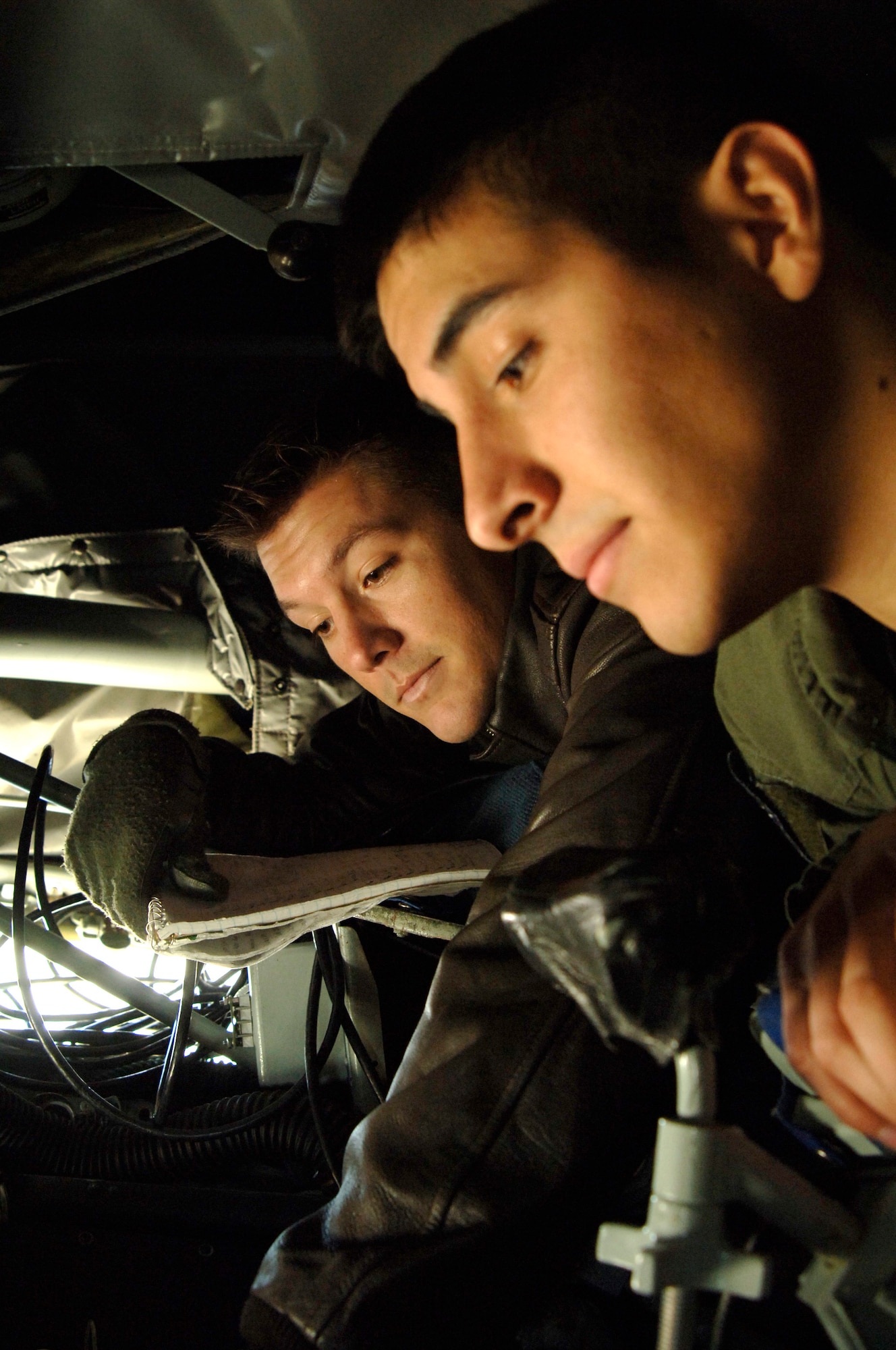 MCCONNELL AIR FORCE BASE, Kan. -- Senior Airman Rob Poe, 349th Air Refueling Squadron, trains Senior Airman Jeremiah Ibarra, 349th Air Refueling Squadron, on the in-flight refueling system on Nov. 26. In-flight refueling system operators make a difference by safely and completely checking the aircraft before any mission. (Photo by Airman 1st Class Roy Lynch III)