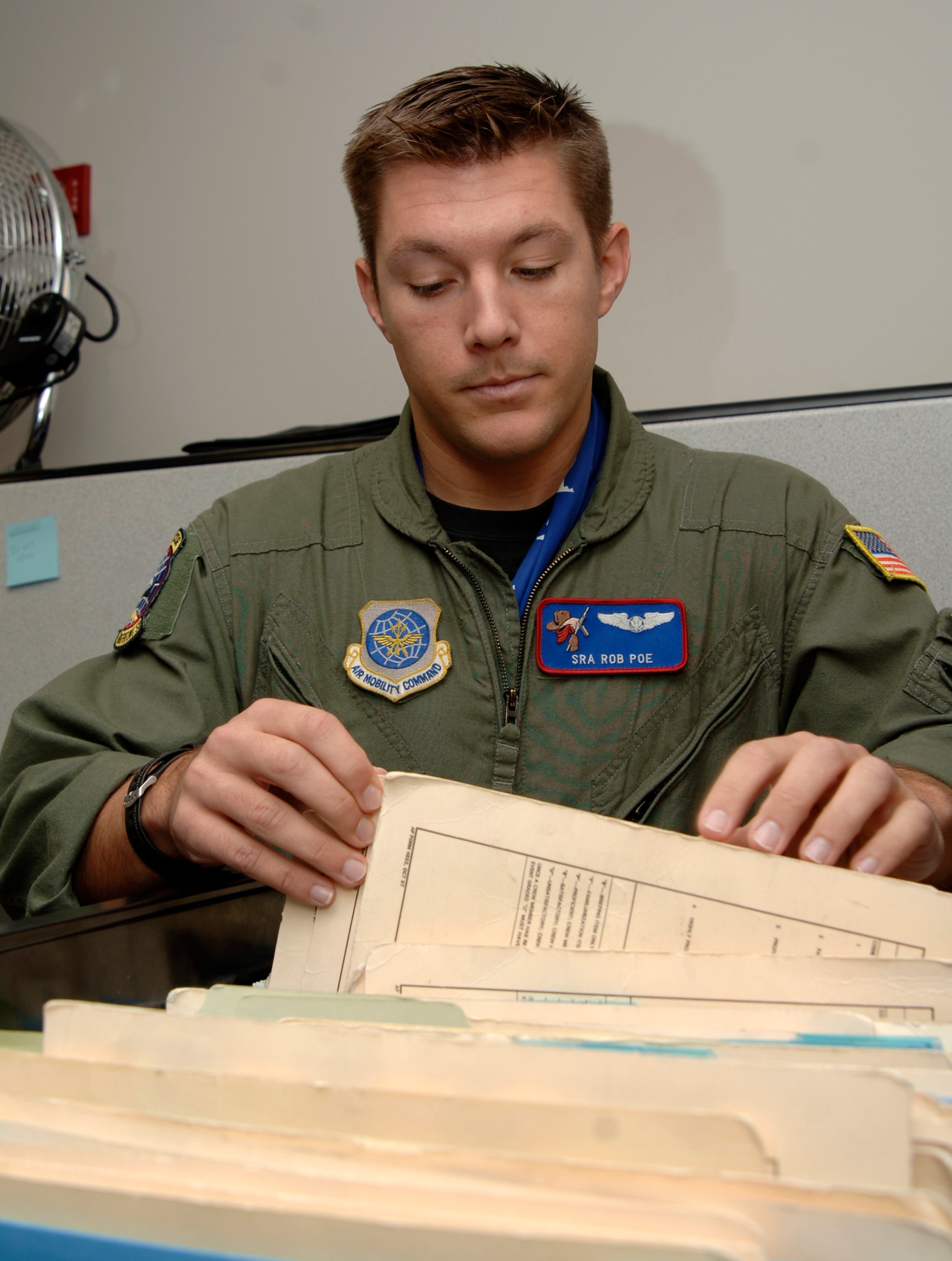 MCCONNELL AIR FORCE BASE, Kan. -- Senior Airman Rob Poe, 349th Air Refueling Squadron, pulls training records for the days training session on Nov. 26. In-flight refueling system operators make a difference by safely and completely checking the aircraft before any mission. (Photo by Airman 1st Class Roy Lynch III)