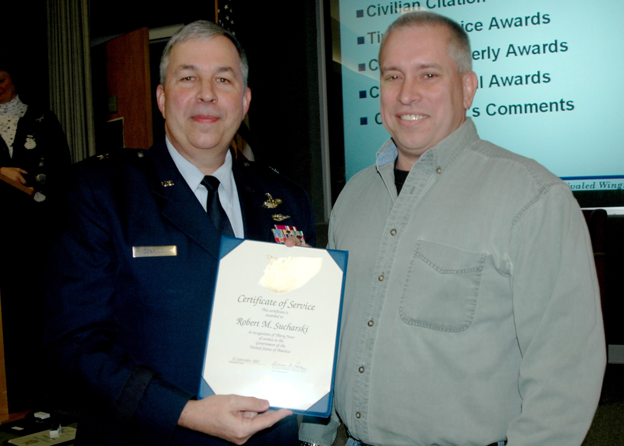 GRISSOM AIR RESERVE BASE, Ind., -- Brig. Gen. Dean Despinoy, 434th Air Refueling Wing commander, left, presents Master Sgt. Bob Sucharski, a maintenance operations controller with the 434th Maintenance Operations Flight, a certificate marking his 30 years of civil service. General Despinoy presented the award during a special civilian commander's call held recently.  (U.S. Air Force photo/Tech. Sgt. Douglas Hays)