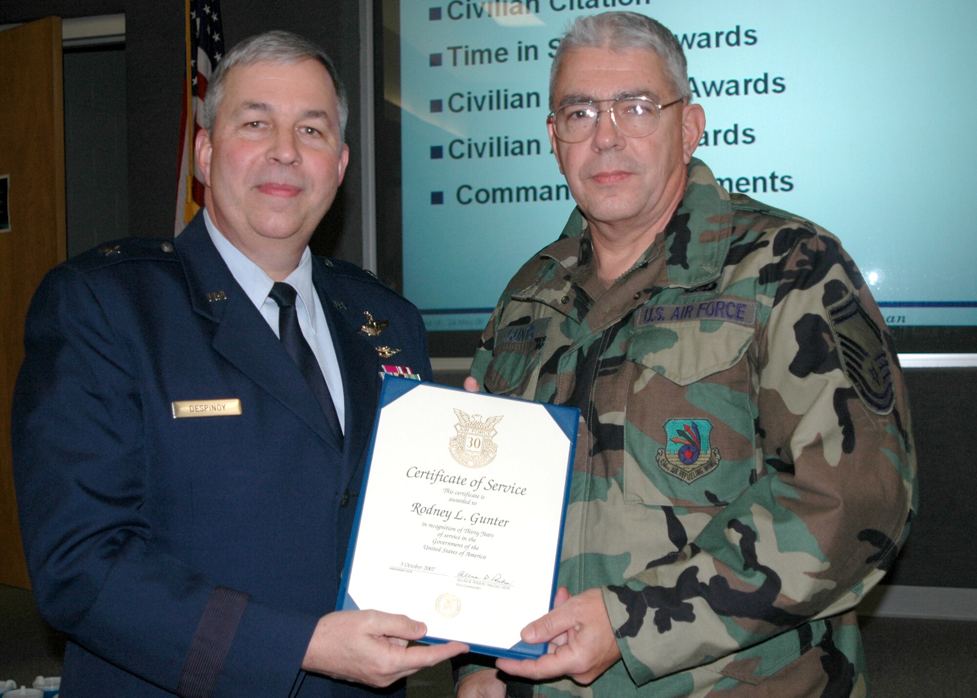 GRISSOM AIR RESERVE BASE, Ind., -- Brig. Gen. Dean Despinoy, 434th Air Refueling Wing commander, left, presents Senior Master Sgt. Rodney Gunter, 434th Aircraft Maintenance Squadron, a certificate marking his 30 years of civil service. The presentation was made during civilian commander's call held recently. (U.S. Air Force photo/Tech. Sgt. Doug Hays)