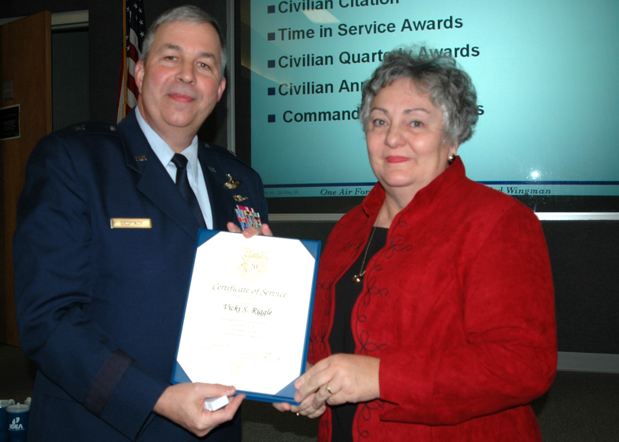 GRISSOM AIR RESERVE BASE, Ind., -- Brig. Gen. Dean Despinoy, 434th Air Refueling Wing commander, presents Vicki Riggle, 434th Maintenance Group, a certificate for 20 years of federal service during a special civilian commander's call held recently. (U.S. Air Force photo/Tech. Sgt. Douglas Hays)