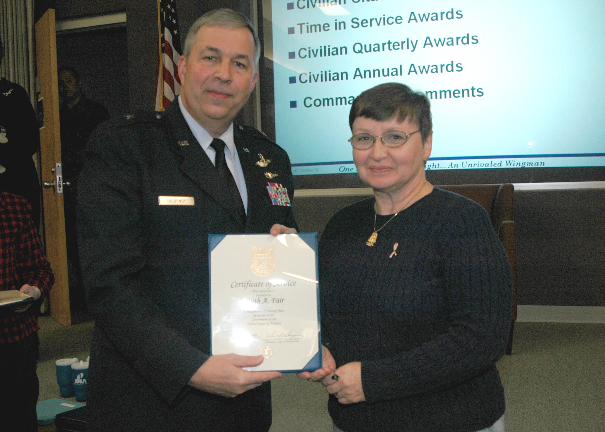 GRISSOM AIR RESERVE BASE, Ind., -- Brig. Gen. Dean Despinoy, 434th Air Refueling Wing commander, presents Ruth Fair, 434th Maintenance Operations Flight, a certificate for 20 years of federal service during a recent civilian commander's call. (U.S. Air Force photo/Tech. Sgt. Douglas Hays)