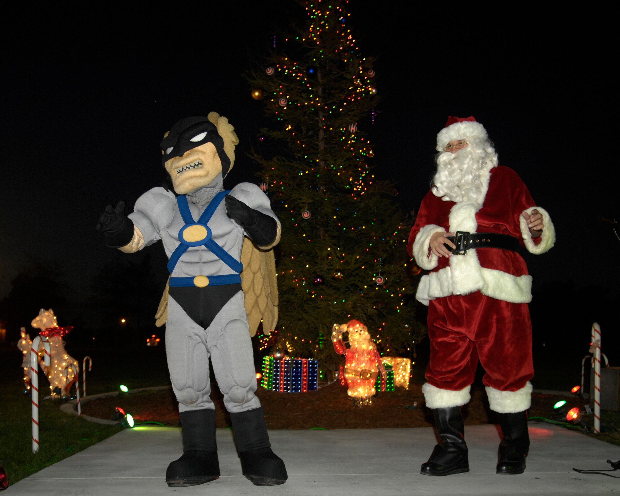 VANDENBERG AIR FORCE BASE, Calif. --  Hawkman and Santa Claus sing Christmas carols during the tree lighting ceremony here on Dec. 4. The ceremony was held in the spirit of the holiday season.  (U.S. Air Force photo/Airman 1st Class Matthew Plew) 