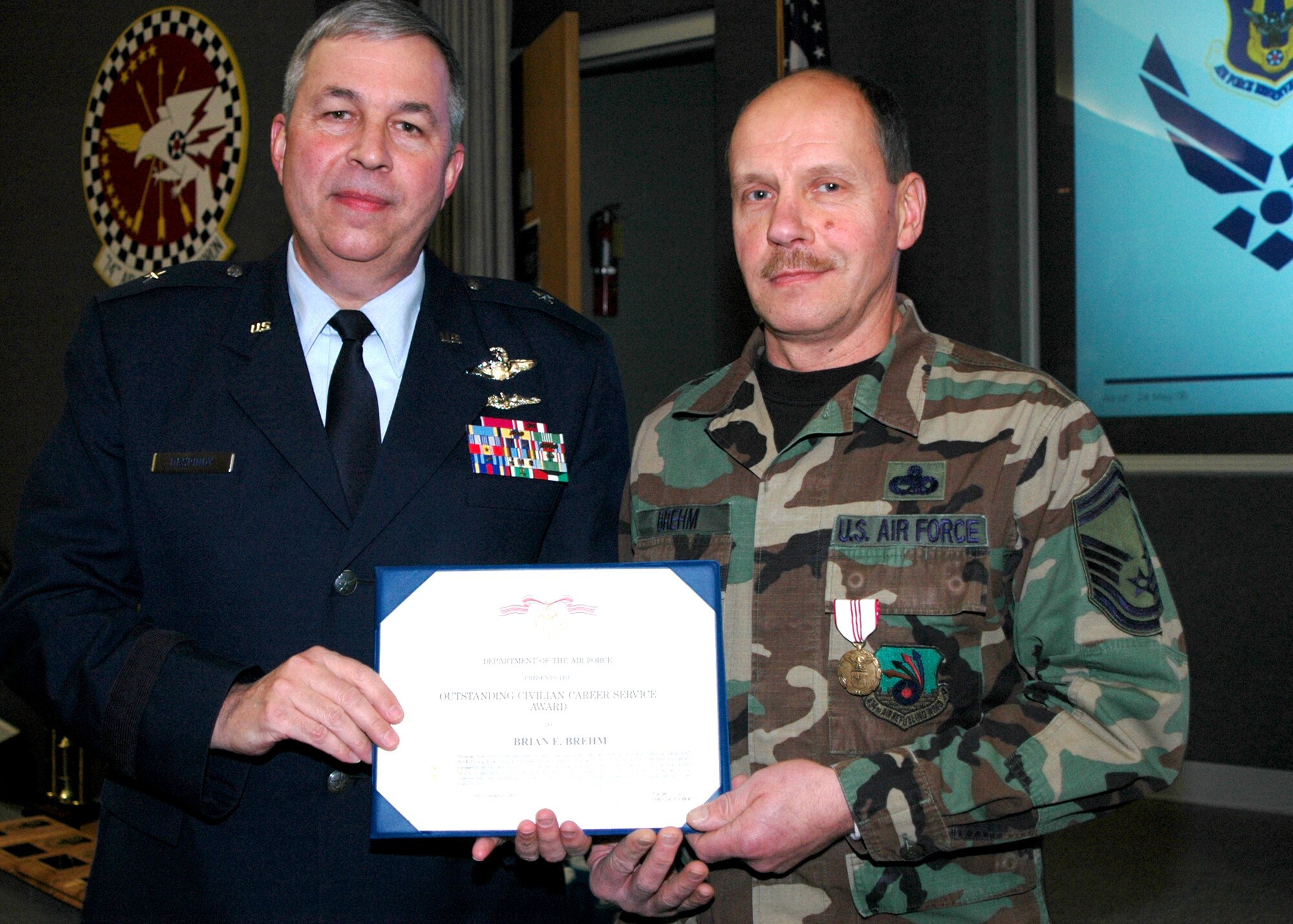GRISSOM AIR RESERVE BASE, Ind., -- Brig. Gen. Dean Despinoy, 434th Air Refueling Wing commander, left, presents an Outstanding Civilian Career Service Award to Senior Master Sgt. Brian Brehm, 434th Aircraft Maintenance Squadron, during a civilian commander's call held recently. (U.S. Air Force photo/Tech. Sgt. Douglas Hays)
