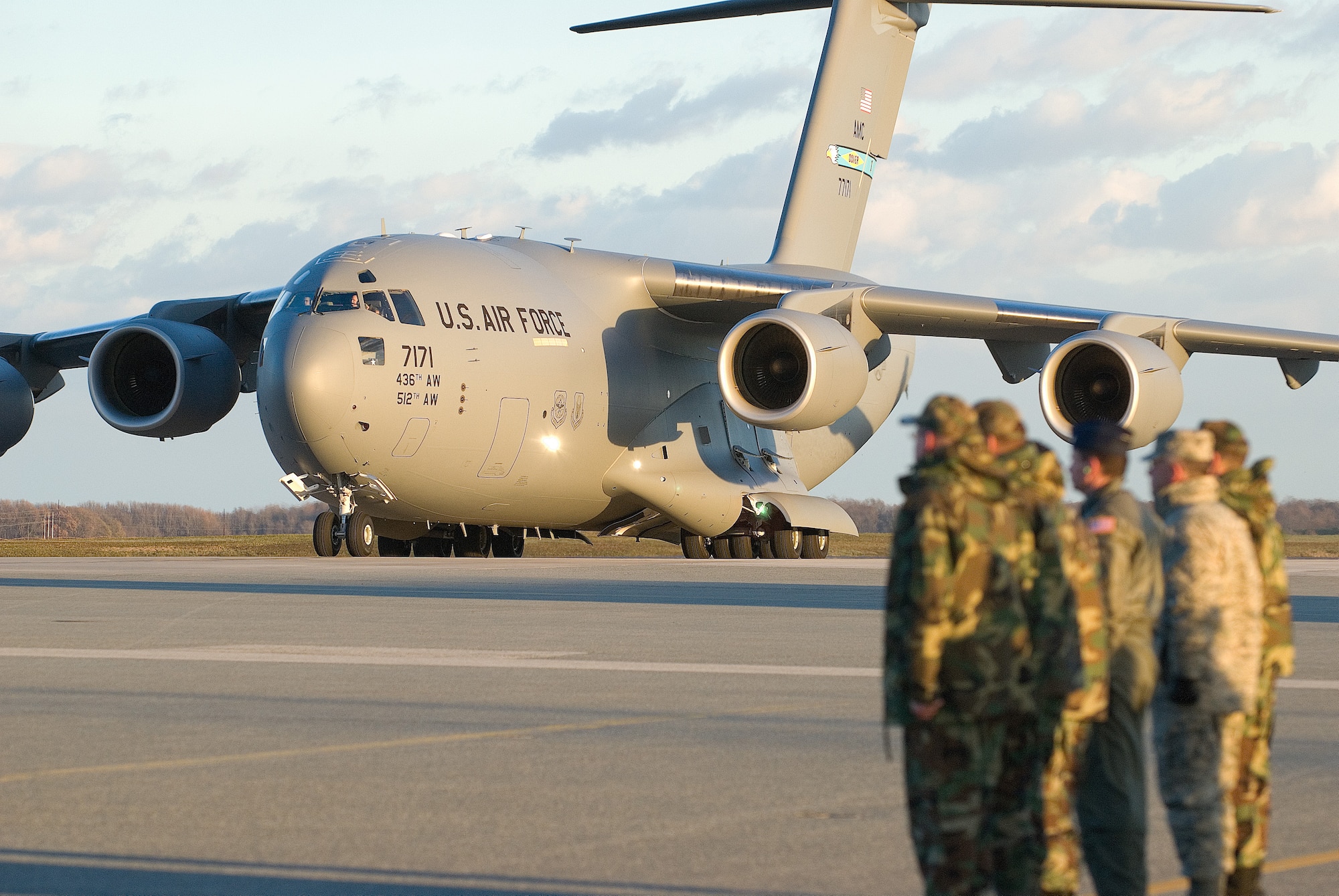 Team Dover leadership stands at attention on the flightline Wednesday as the base’s seventh C-17 Globemaster III is delivered. Brig. Gen. S. “Taco” Gilbert III, Director of Strategic Plans, Requirements and Programs, Headquarters Air Mobility Command, delivered the craft. The arrival of this plane marks the halfway point in the delivery schedule as the base is slated to receive 13 C-17s by the end of 2008. (U.S. Air Force photo/Roland Balik)