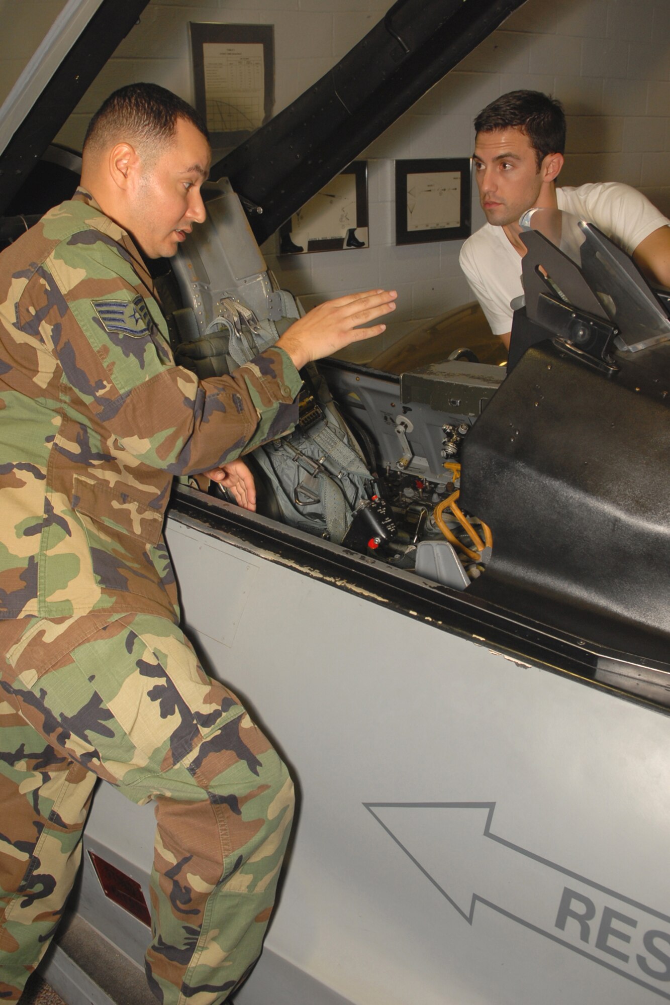 Staff Sgt. Heriberto Rodriques-Rivas, 56th Operations Support Squadron Aircrew Flight equipment specialist, conducts aircrew continuation training with Milo Ventimiglia, star of the NBC TV series ‘Heroes,’ when he visited Luke Nov. 15. Mr. Ventimiglia was receiving the training in preparation for an orientation flight provided
by the 944th Fighter Wing.