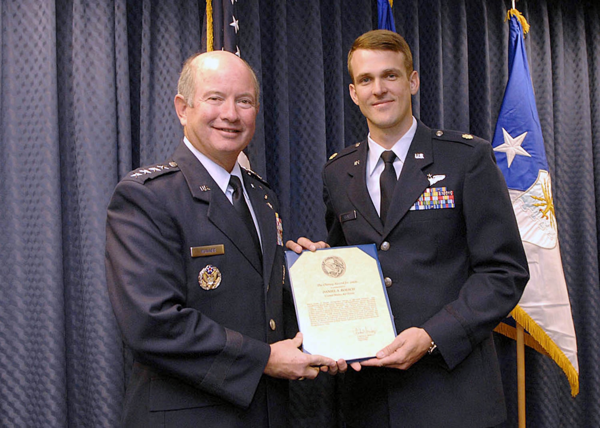 Air Force Vice Chief of Staff Gen. Duncan J. McNabb presents Maj. Daniel Roesch the Cheney Award for actions in southern Afghanistan. The Cheney Award is presented each year in memory of 1st Lt. William Cheney, who was killed in an air collision over Italy in 1918. Major Roesch is an MC-130H Combat Talon II navigator. (U.S. Air Force photo/Andy Morataya)