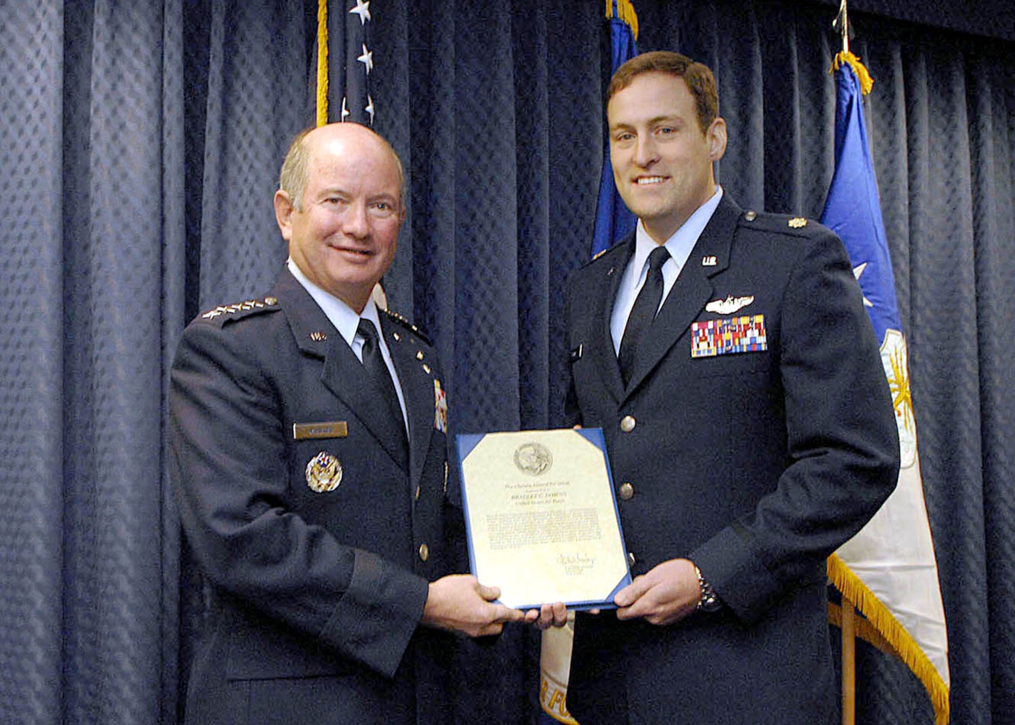 Air Force Vice Chief of Staff Gen. Duncan J. McNabb presents Maj. Bradley Downs the Cheney Award for his actions in southern Afghanistan. The Cheney Award is presented each year in memory of 1st Lt. William Cheney, who was killed in an air collision over Italy in 1918. Major Downs is an MC-130H Combat Talon II pilot. (U.S. Air Force photo/Andy Morataya)