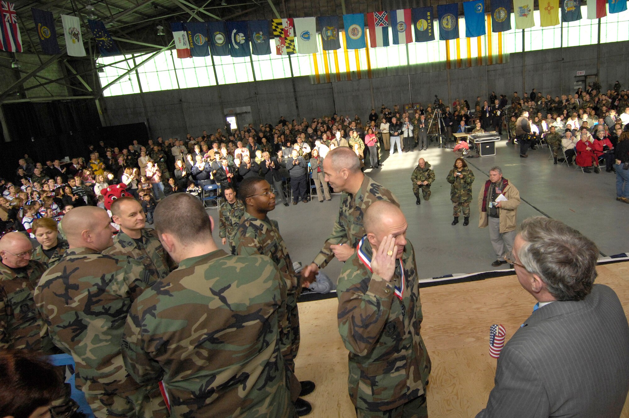 HANSCOM AFB, Mass. -- Recently returned deployers from Hanscom are welcomed home by base leaders and a cheering crowd of co-workers, relatives and local community members during a homecoming celebration Dec. 5 in the base’s Aero Club Hangar. (U.S. Air Force photo by Mark Wyatt)