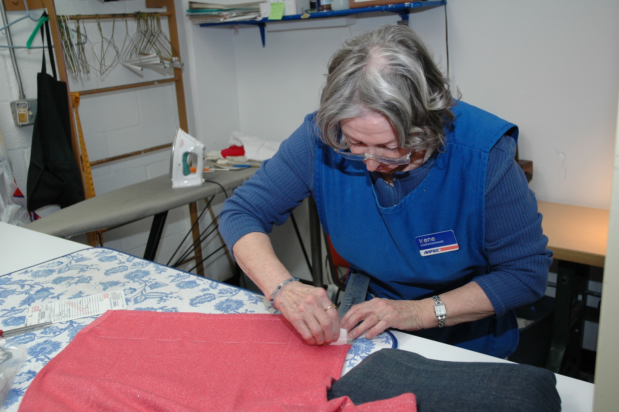 Ms. Harris marks a sweater before cutting off excess material and putting in a new hem. (U.S. Air Force photo/Valerie Mullett)