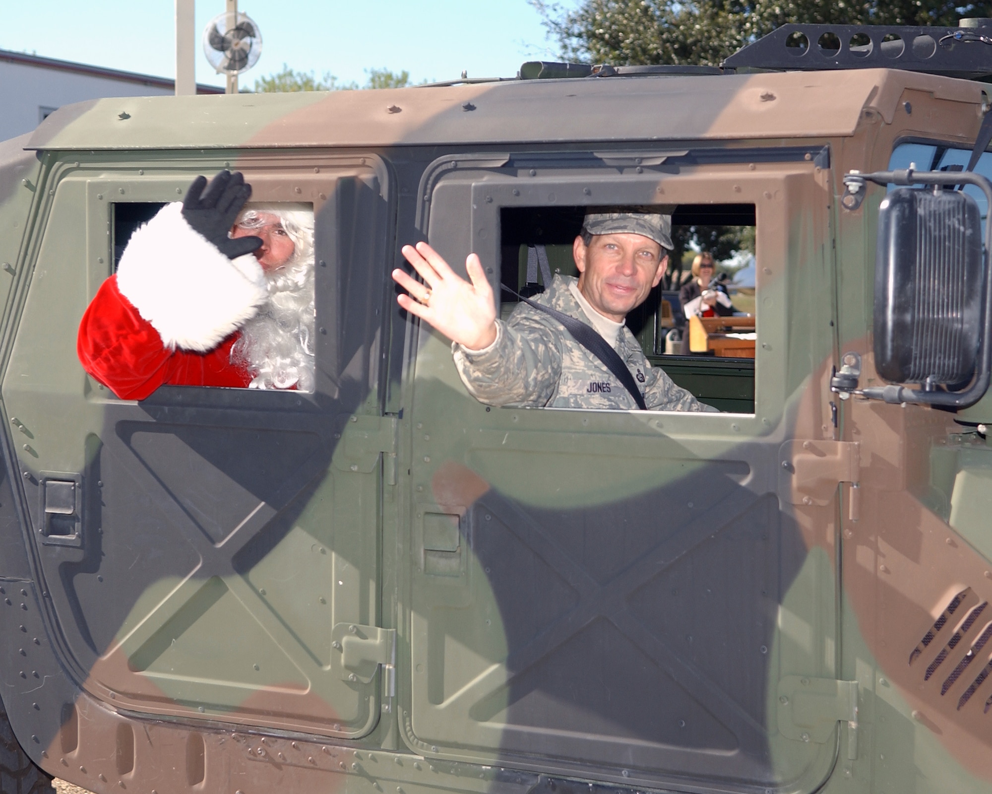 Brig. Gen. Darrell D. Jones and Santa head out in a military vehicle after being part of a statewide campaign to remind people to not drink and drive Dec. 4 at Lackland Air Force Base, Texas. The Texas Department of Transportation used Lackland AFB as a backdrop to announce the beginning of its annual four-week drunk driving prevention campaign. This is the 10th year of the Texas Department of Transportation's holiday public education campaign. General Jones is the commander of the 37th Training Wing. (U.S. Air Force photo/Alan Boedeker)