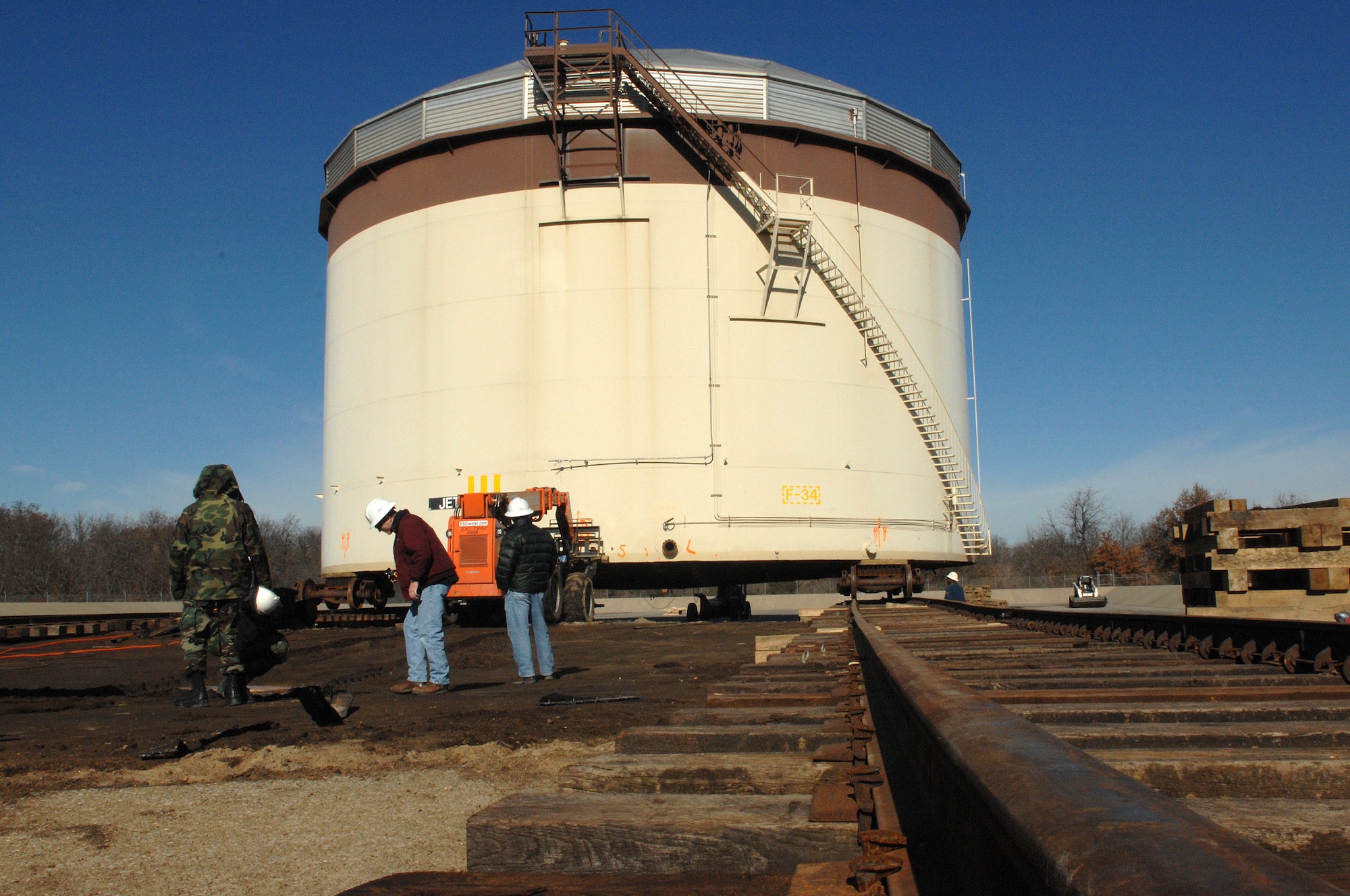 WHITEMAN AIR FORCE BASE, Mo. - Members of the 509th Logistics Readiness and Civil Engineer Squadrons  move a fuel tank Dec. 4. (U.S. Air Force photo/Staff Sgt. Charles Larkin)