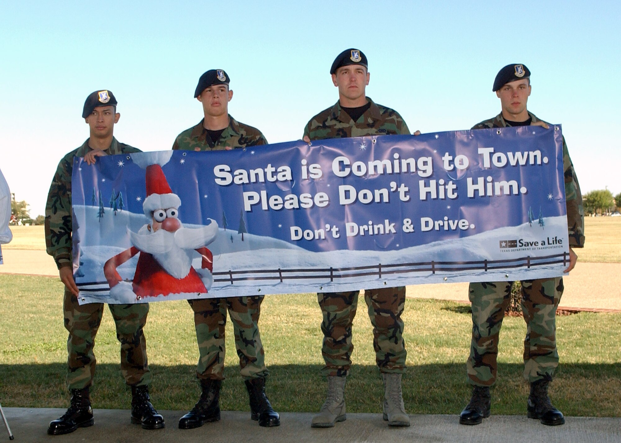 Airman 1st Class Randolph Rivera, Airman Michael Gans, Airman 1st Class Kurt Cornwell and Airman 1st Class Austin Best hold a Texas Department of Transportation drunk driving awareness campaign poster Dec. 4 at Lackland Air Force Base, Texas. This is the 10th year of the Texas Department of Transportation's holiday public education campaign. The Airmen are from the 37th Security Forces Squadron. (U.S. Air Force photo/Alan Boedeker)
