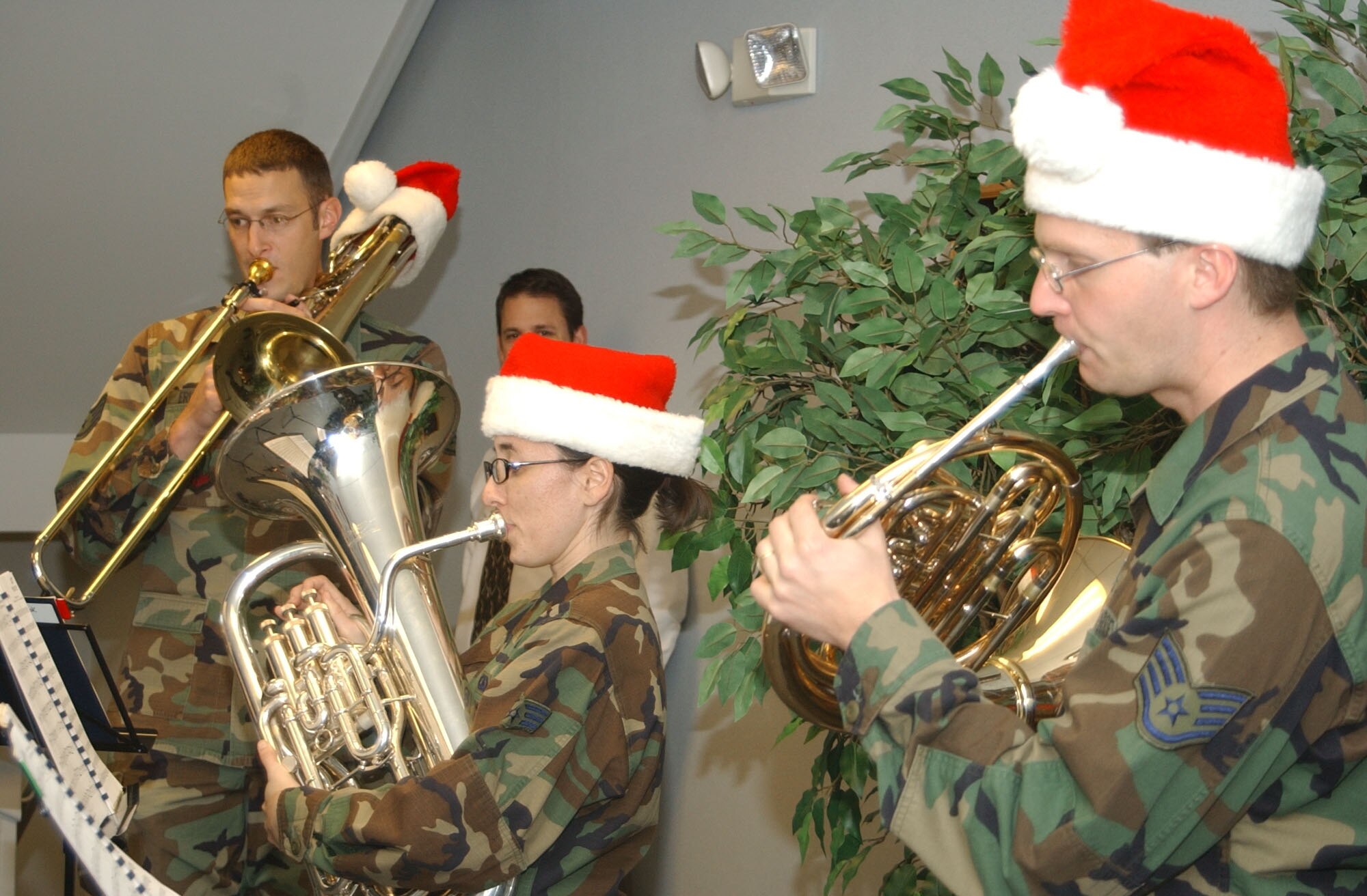 Members of the Heartland of America Band, left to right, Staff Sgt. Matt Erickson on trombone; Airman 1st Class Meredith Healy on euphonium; and Staff Sgt. Ryan Heseltine on horn, perform holiday music during a stop at the 341st Mission Support and Comptroller Squadrons. The band was at Malmstrom Nov. 27 and 28 to help kick off the holiday season. (U.S. Air Force photo/2nd Lt. Korry Leverett)