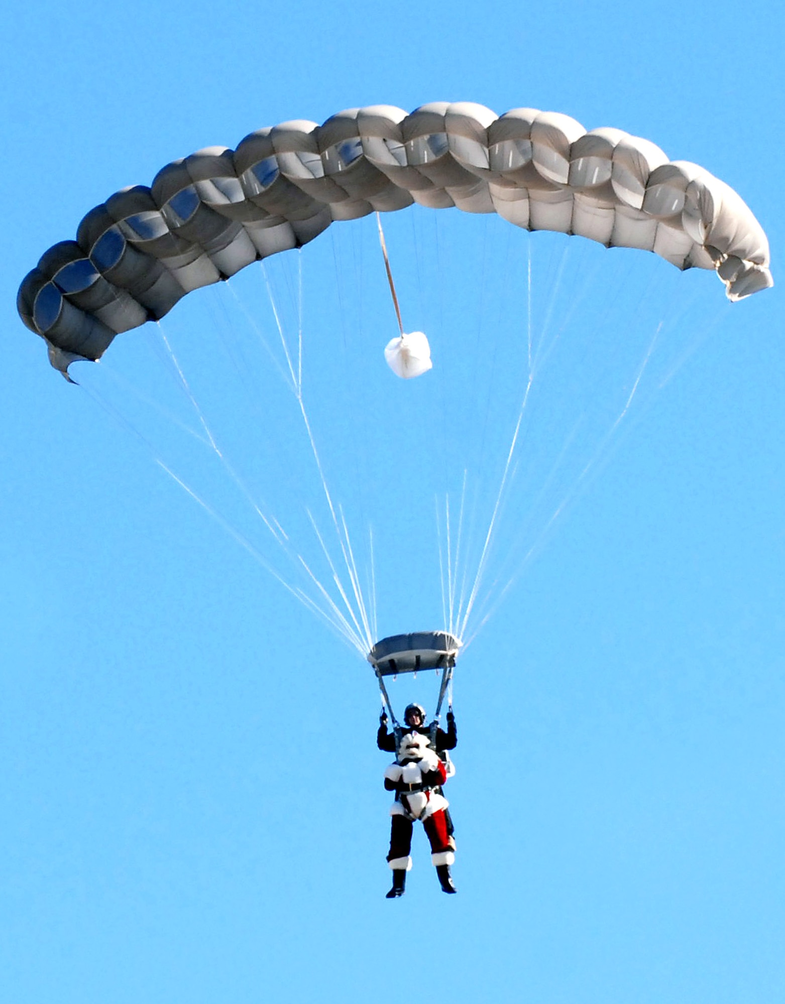 Santa Claus skydives onto the 37th Training Wing parade field to help the Texas Department of Transportation kick off its annual four-week drunk driving prevention campaign Dec. 4 at Lackland Air Force Base, Texas. This is the 10th year of the holiday public education campaign. (U.S. Air Force photo/Alan Boedeker)
