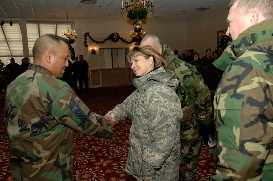 HANSCOM AFB, Mass. -- Lt. Gen. Terry Gabreski, vice commander of the Air Force Materiel Command, shakes hands with Senior Master Sgt. Raul Ruiz, Mission Support Squadron first sergeant, during a reception in the Minuteman Club yesterday, while 66th Air Base Wing Vice Commander Col. Jeff Mayo (far right) and 66th Mission Support Group Commander Col. Robert Boyles look on.  General Gabreski visited Hanscom Tuesday and Wednesday to participate in a Senior Executive Service selection board. (U.S. Air Force photo by Mark Wyatt.)
