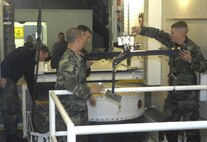 MINOT AIR FORCE BASE, N.D. -- A missile maintenance team prepares to unload a missile guidance set off a payload transporter for storage in the MGS vault. The last NS-20 missile guidance set  was removed and replaced by a newer guidance replacement program (GRP) NS-50 MGS Dec. 4. The GRP primary modification provides the warfighter updated guidance electronics without degrading Minuteman III accuracy. This upgrade replaced the guidance computer and software, while reusing the existing gyro stabilized platform. The upgrades are part of a program to extend the viability of the Minuteman III missiles to 2030.  (U.S. Air Force photo by Airman 1st Class Joe Rivera)