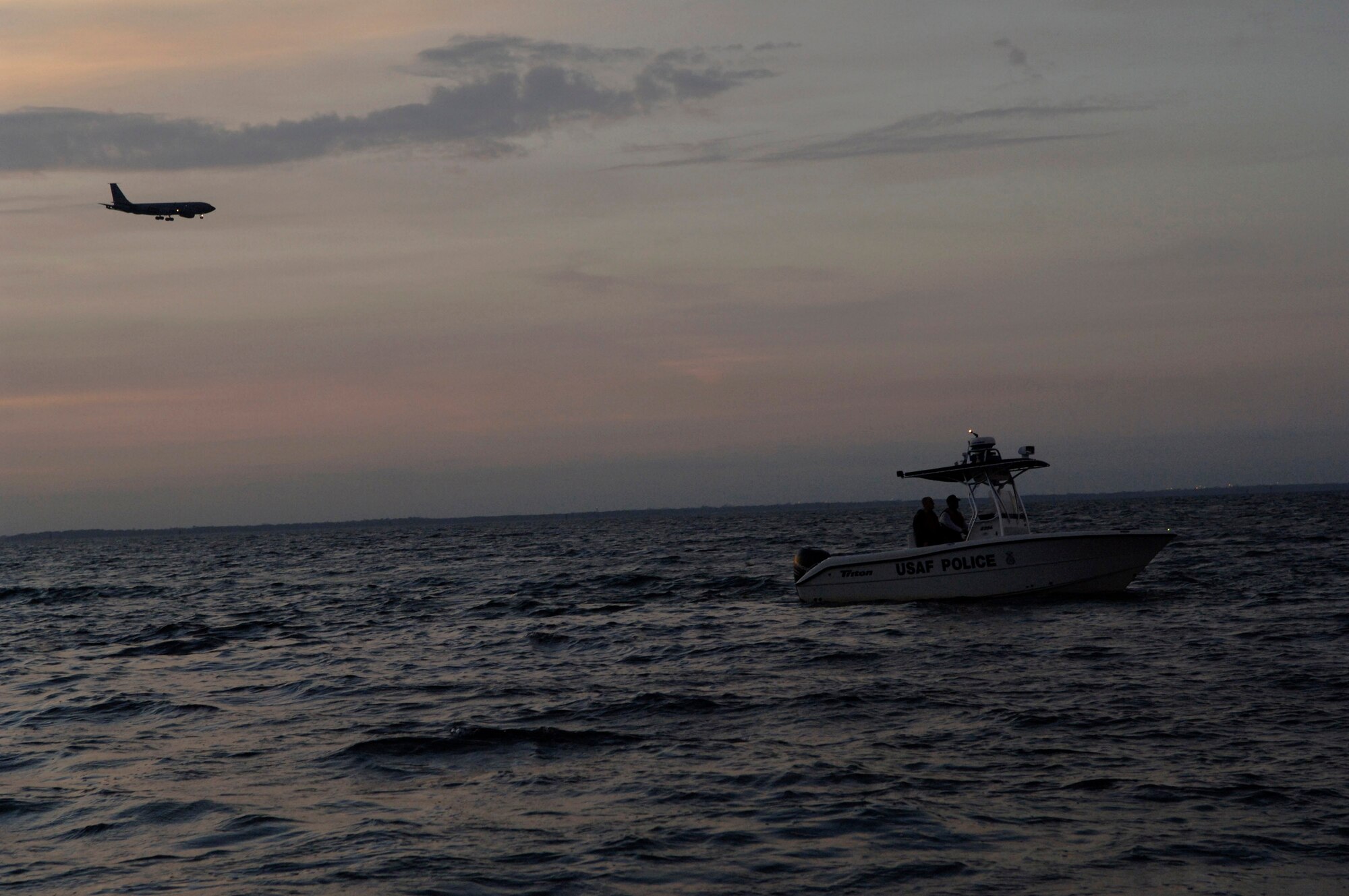 Members from the 6th Security Forces Squadron boat patrol at MacDill Air Force Base, Fla. police Tampa Bay Nov. 27 as a KC-135 Stratotaker prepares to land. The 6th SFS is one of the few security forces squadrons in the Air Force to have a boat patrol and the only one to patrol overnight. (U.S. Air Force photo/Airman Rylan Albright) 