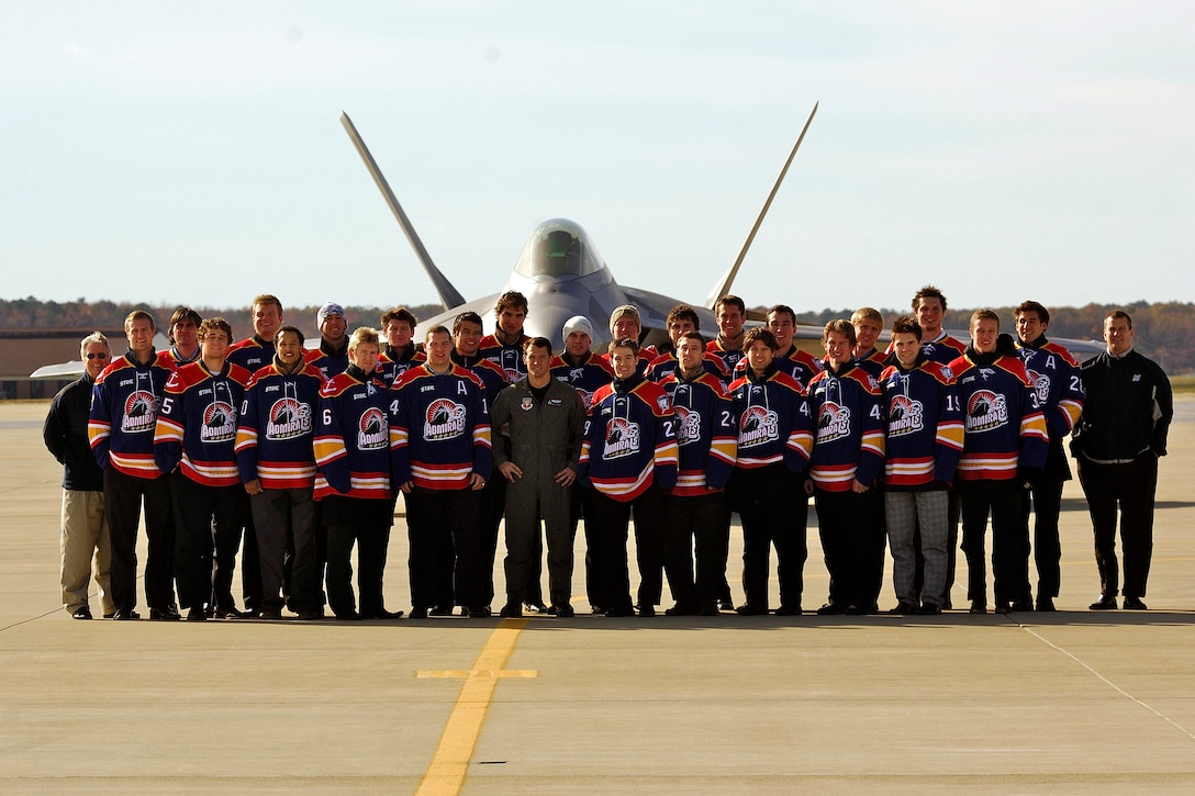 LANGLEY AIR FORCE BASE, Va.--The Norfolk Admirals hockey team poses with Maj. Paul "Max” Moga, F-22 Demo Team pilot, in front of a Raptor here Dec. 4. The Admirals are the top developmental affiliate of the National Hockey League’s Tampa Bay Lightning. (U.S. Air Force photo/Staff Sgt. Samuel Rogers)
