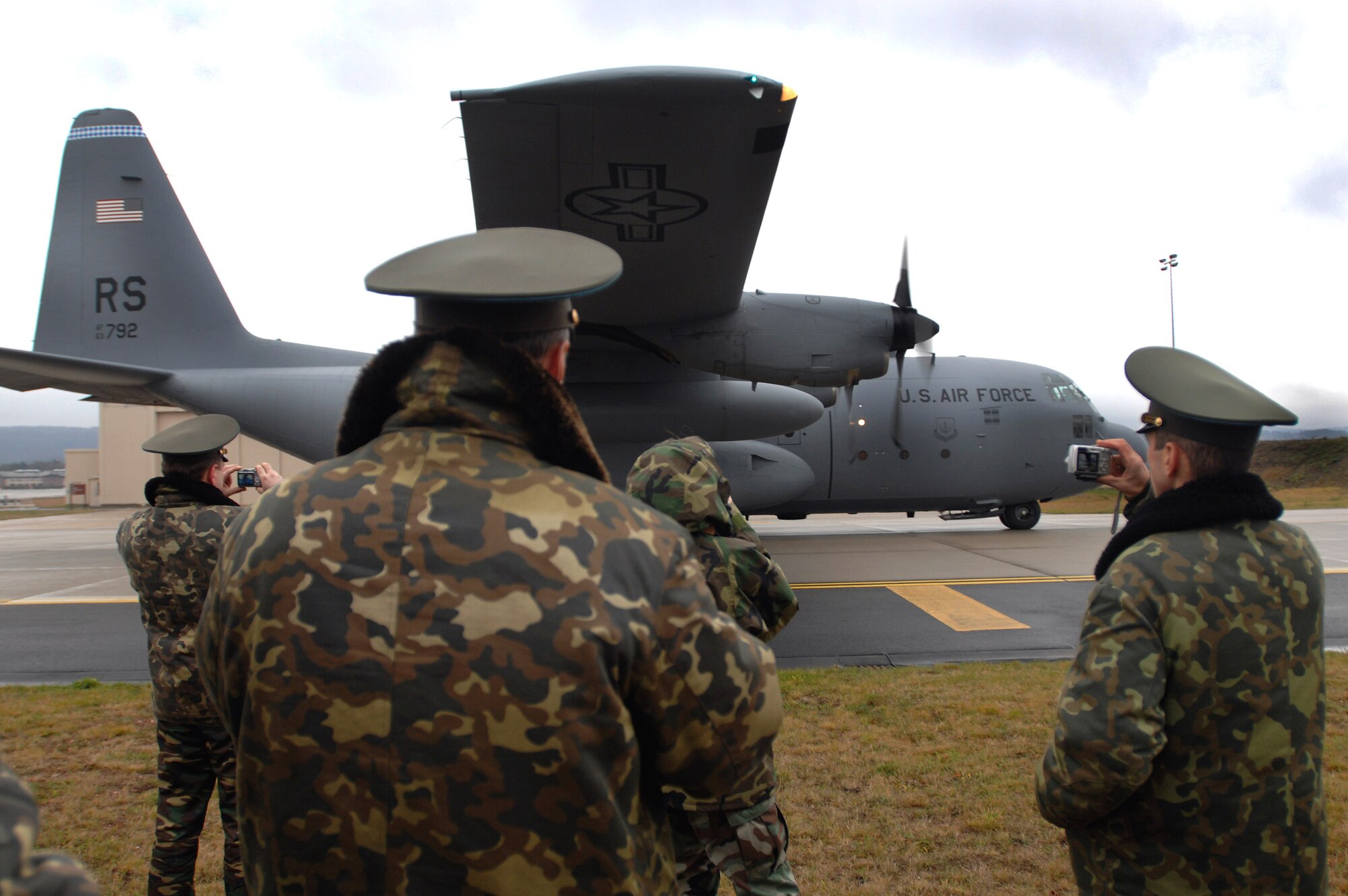 Russian air force officers take photos as a C-130 Hercules prepares for a combat offload demonstration Dec. 5 at Ramstein Air Base, Germany. The demonstration illustrated one of the many C-130 capabilities for transporting cargo. The Russian air force members visited to plan a United States/Russia exercise demonstrating theater security cooperation among the U.S. Air Forces in Europe and Russian federation air force personnel. (U.S. Air Force photo/Airman 1st Class Kenny Holston)