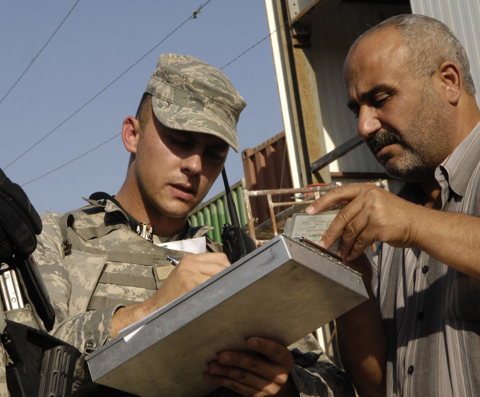 Warrior of the North Senior Airman Rodney Gatts, deployed from the 319th Security Forces Squadron and currently assigned to the 732nd Expeditionary Security Forces Squadron, Detachment 4, completes paperwork necessary after an escort violation was discovered. The violators were then escorted out of the International Zone. Security Forces Airmen are the first responders for the International Zone, Baghdad, Iraq. (U.S. Air Force photo/Staff Sgt Angelique Perez)