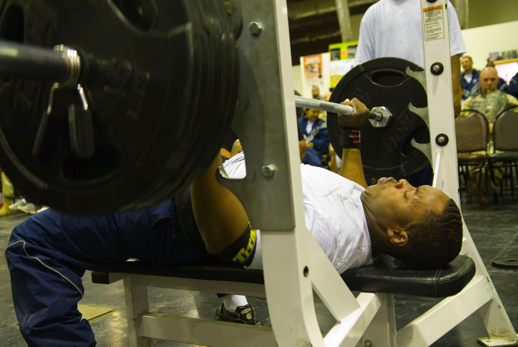 BALAD AIR BASE, Iraq -- Airman 1st Class Henry Smith, 332nd Expeditionary Security Forces Squadron, lifts 315 pounds during the bench press portion of the Strongest Person in the Area of Responsibility contest here, Dec. 5. The event allowed participants to put their strength to the test in three different events: squat, bench press and dead lift. Airman Smith is deployed from Eielson Air Force Base, Alaska. (U.S. Air Force photo/Staff Sgt. Joshua Garcia)