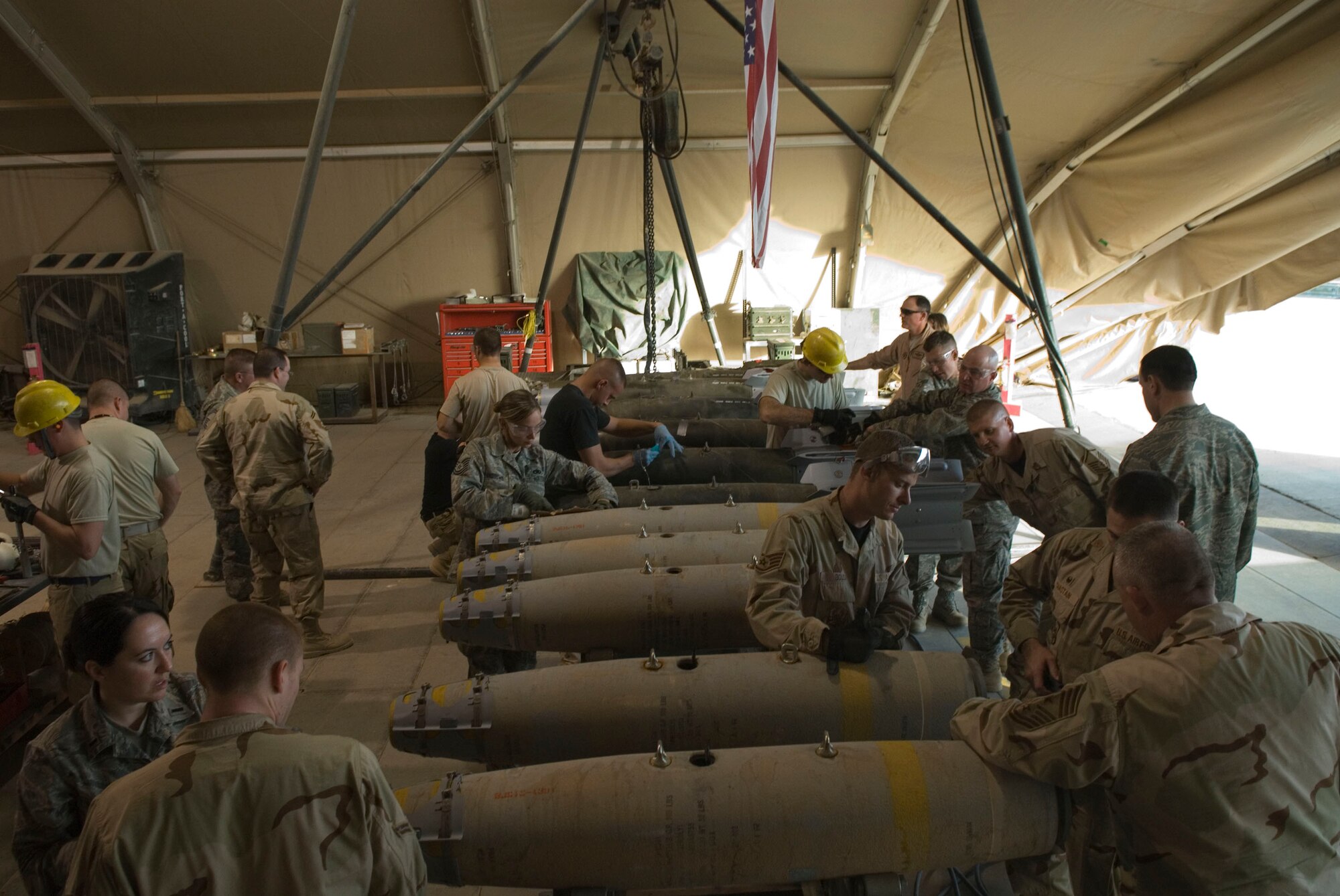 BALAD AIR BASE, Iraq -- 332nd Air Expeditionary Wing leadership and Airmen build bombs here, Dec. 5, for future combat operations. Wing leaders were able to assist members of the 332nd Expeditionary Maintenance Squadron ammunition flight make munitions from start to finish. (U.S. Air Force photo/Staff Sgt. Joshua Garcia)