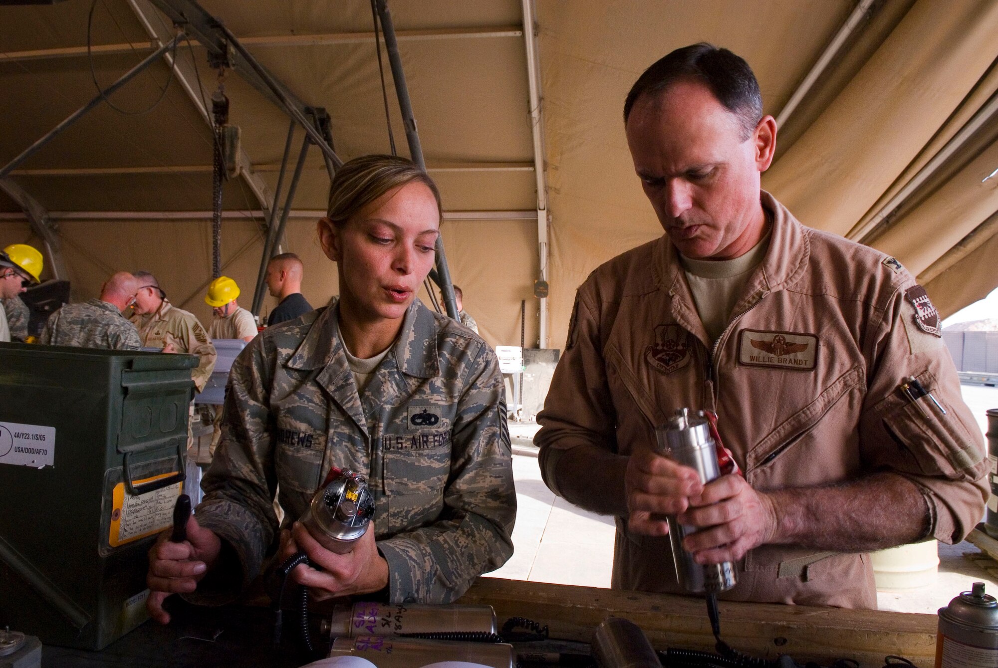 BALAD AIR BASE, Iraq -- Tech. Sgt. Melissa Andrews, 332nd Expeditionary Maintenance Squadron Ammunitions Flight, shows Col. William Brandt, 332nd Air Expeditionary Wing director of staff, how to properly set fuses during a bomb build here, Dec. 5. Colonel Brandt and other members of wing leadership were able to work side by side with Airmen as they built bombs for combat missions. Sergeant Andrews is deployed from Buckley Air Force Base, Colo. and Colonel Brandt is deployed from Kirtland Air Force Base, N.M. (U.S. Air Force photo/Staff Sgt. Joshua Garcia)
